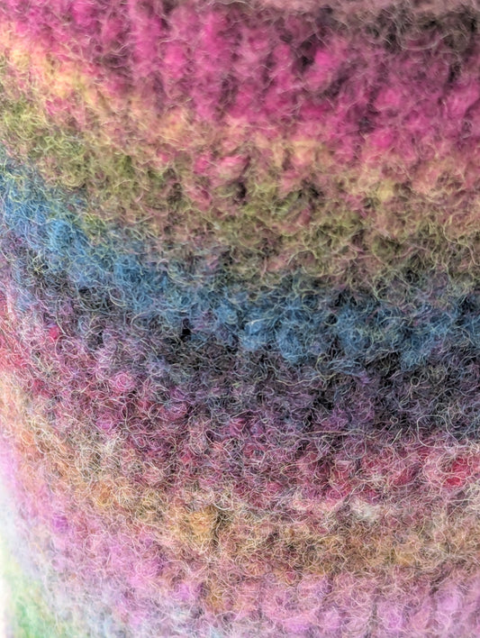 Close-up of a colorful striped mug cozy