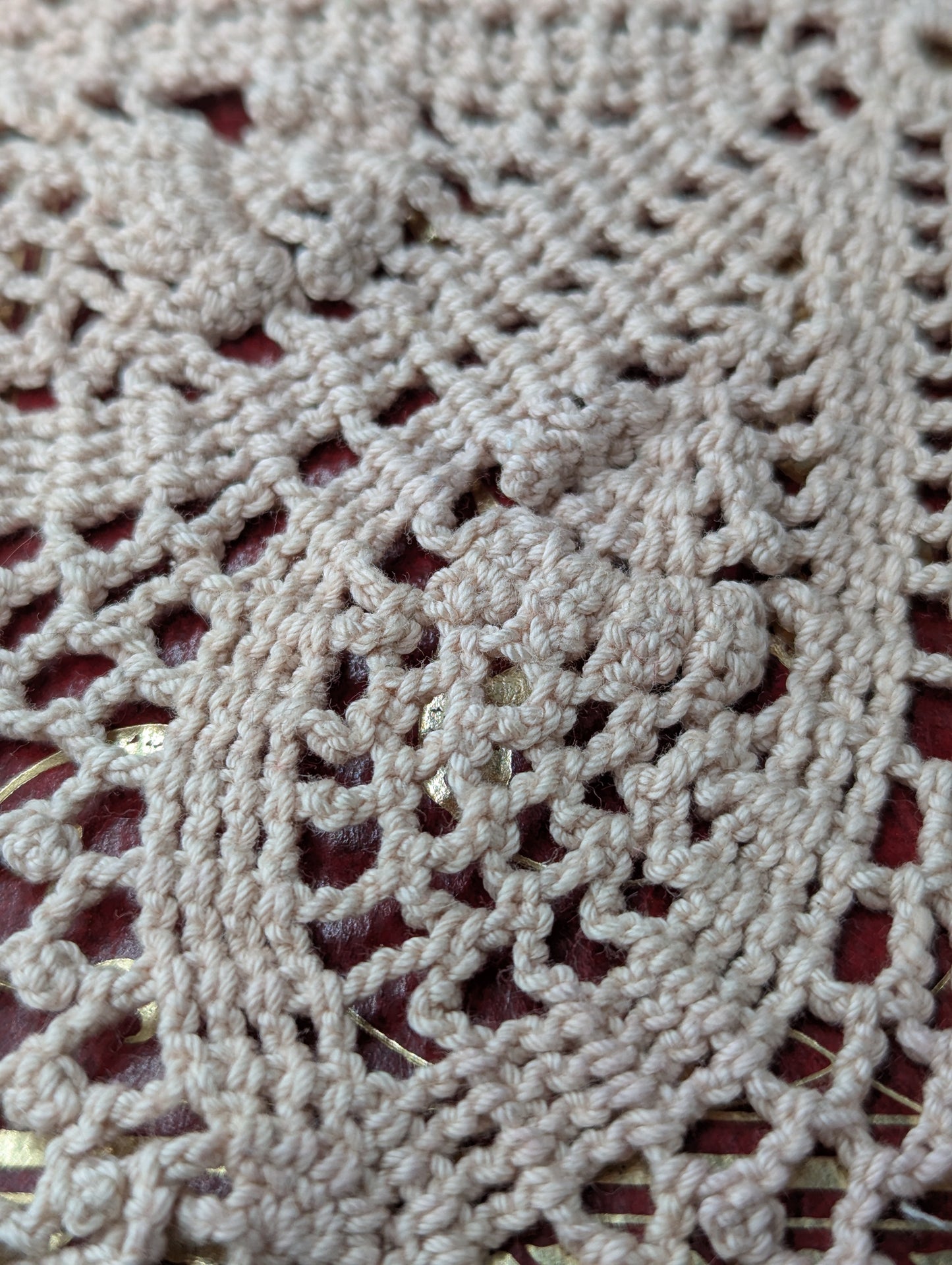 Close up of a crochet doily in a flowers and lace pattern