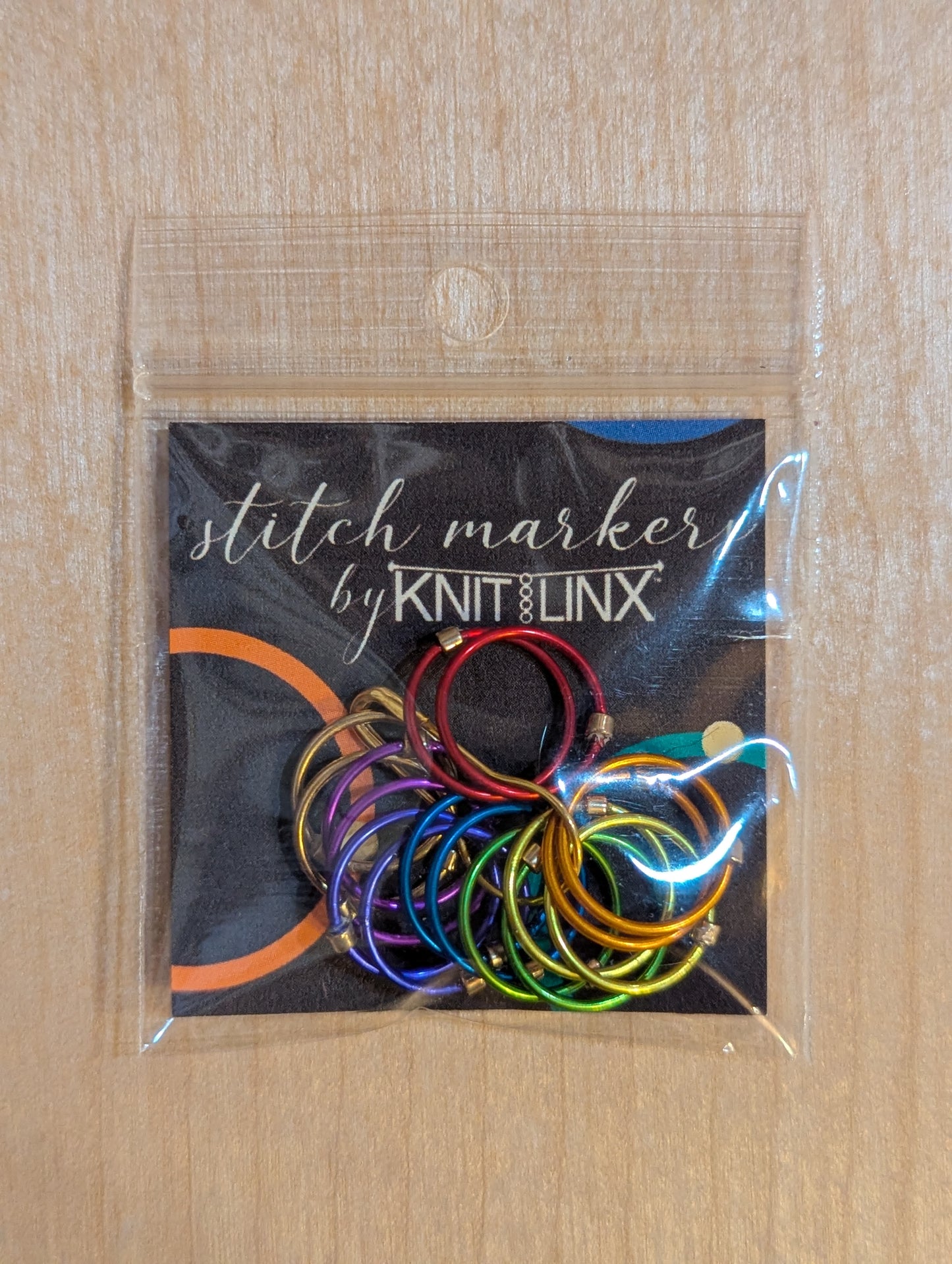 Knitting and crochet stitch markers by KnitLinx for knitting needles size 9 through 13. Made from metal in rainbow colors.