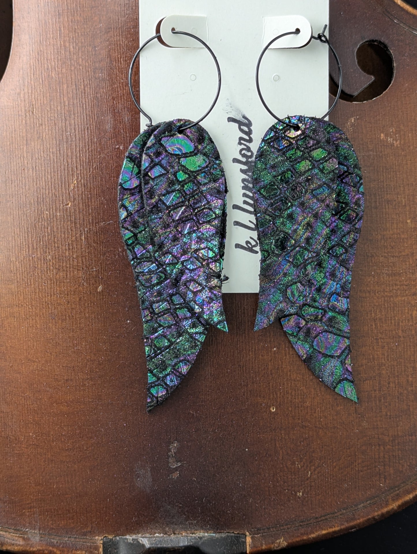 Leather earrings. Deep iridescent colors on black leather with black hoops. 4 inches long.