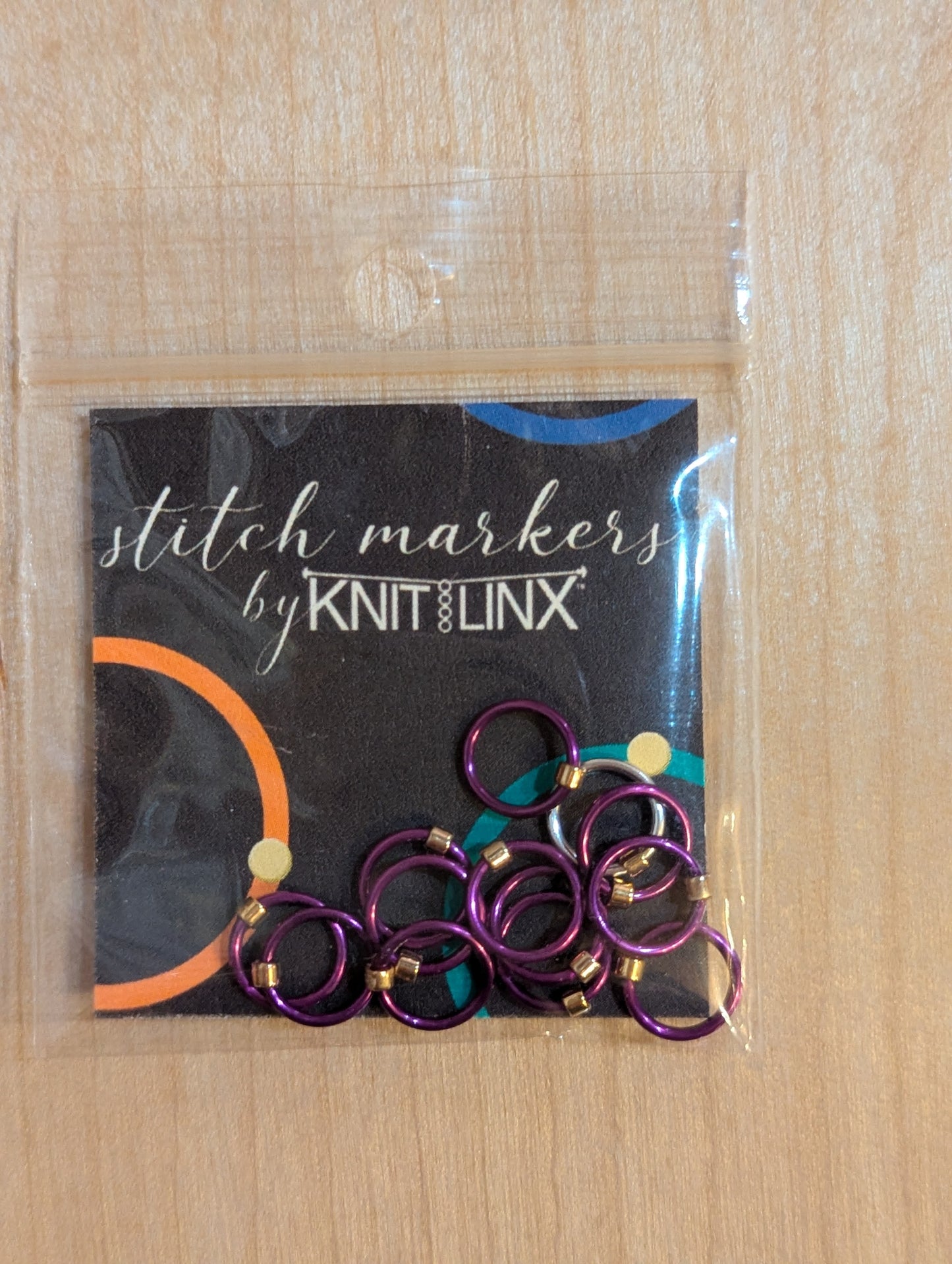 Knitting and crochet stitch markers by KnitLinx for knitting needles size 0 through 8. Made from metal and purple color.