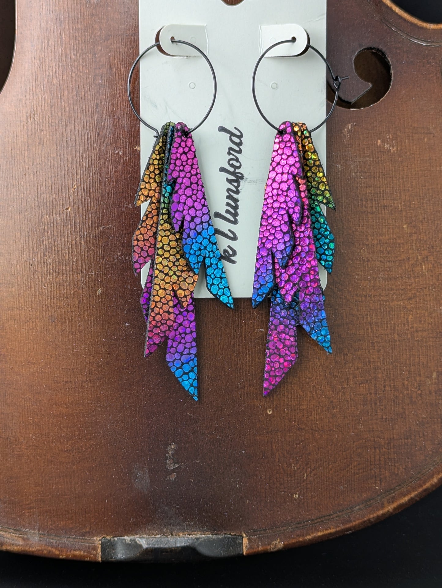 Vibrant, colorful leather earrings on black hoops. 4 inches long.