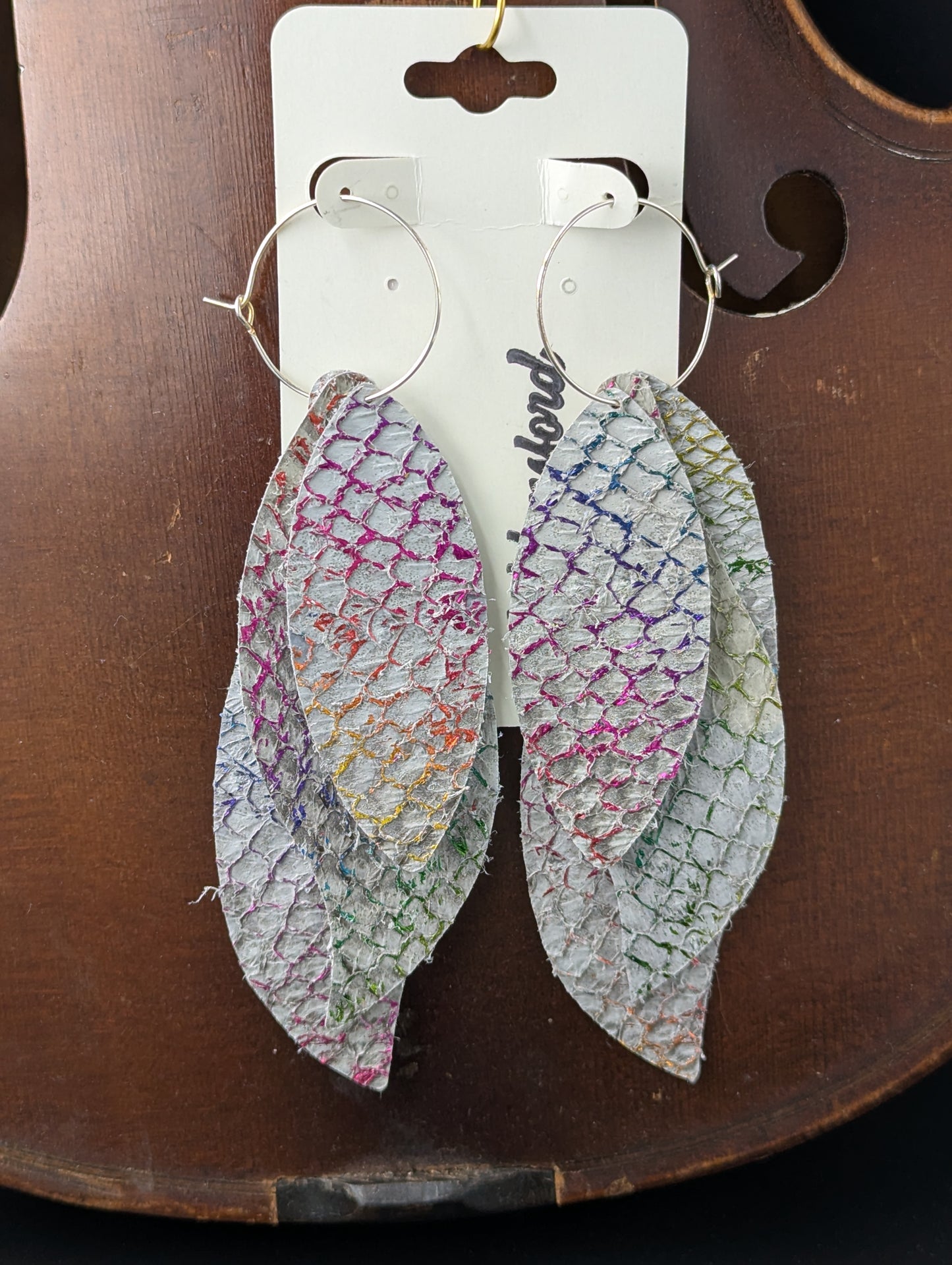 Unique fish leather earrings on silver hoops. Many shimmery colors over a base gray color. 5 inches long.