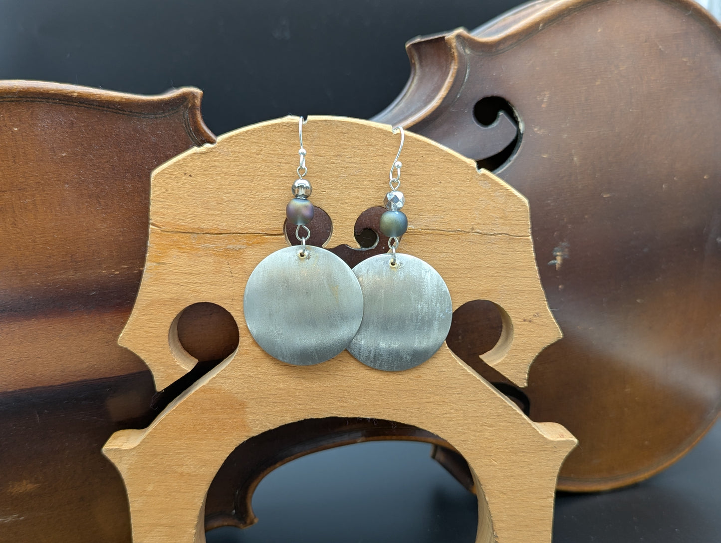 Pair of silver earrings with blue opalescent beads.