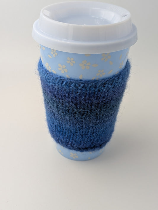 Blue knitted and felted mug cozy