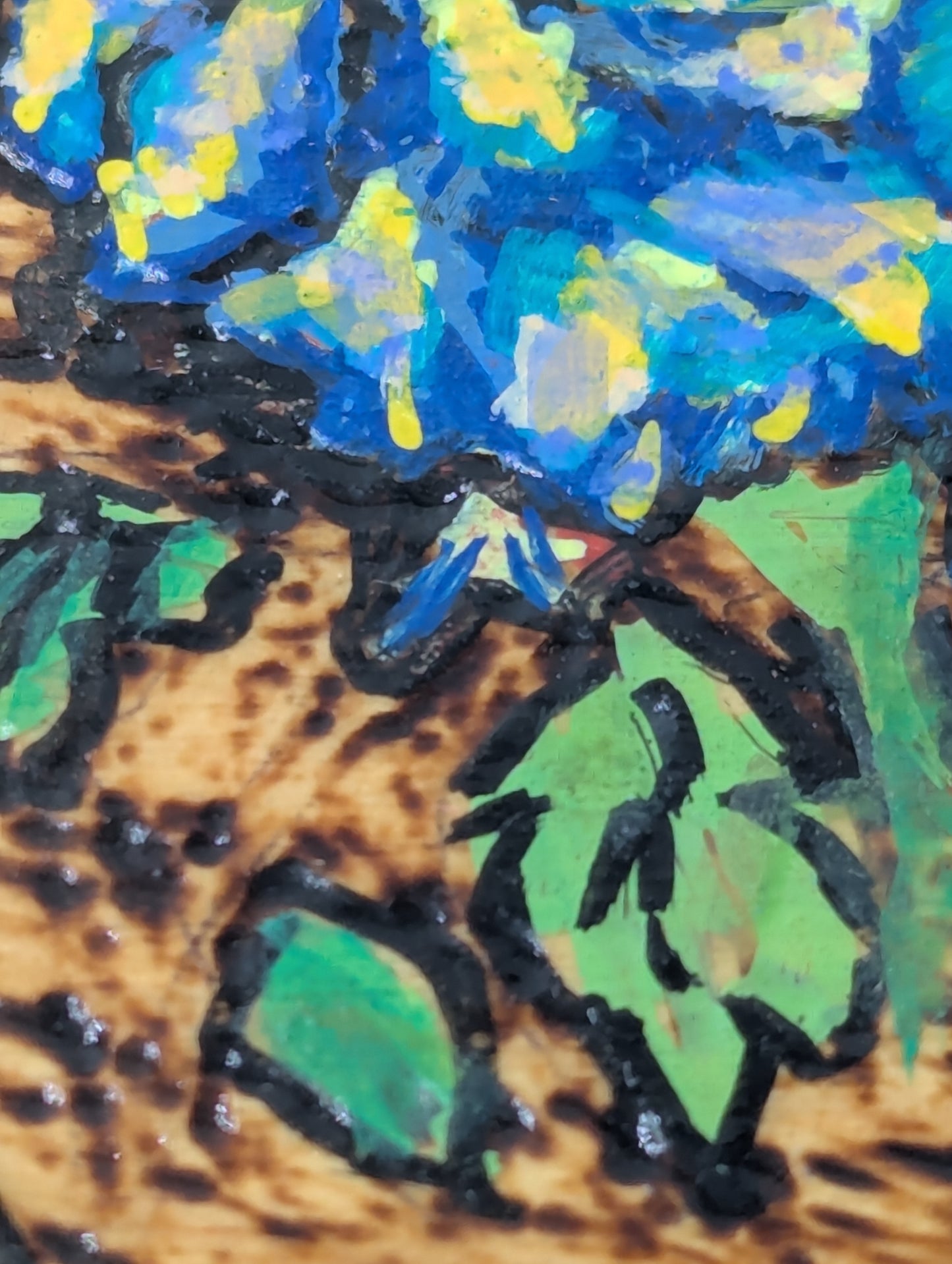 Close up of a hexagonal wooden box with blue rose design 
