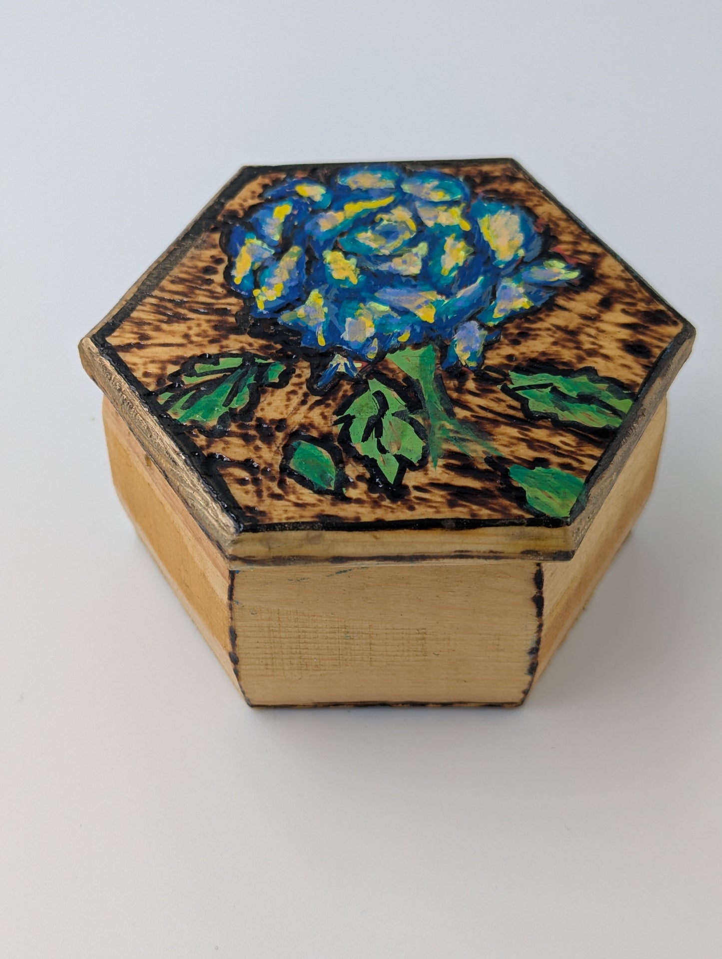 Hexagonal wooden box with blue rose design 