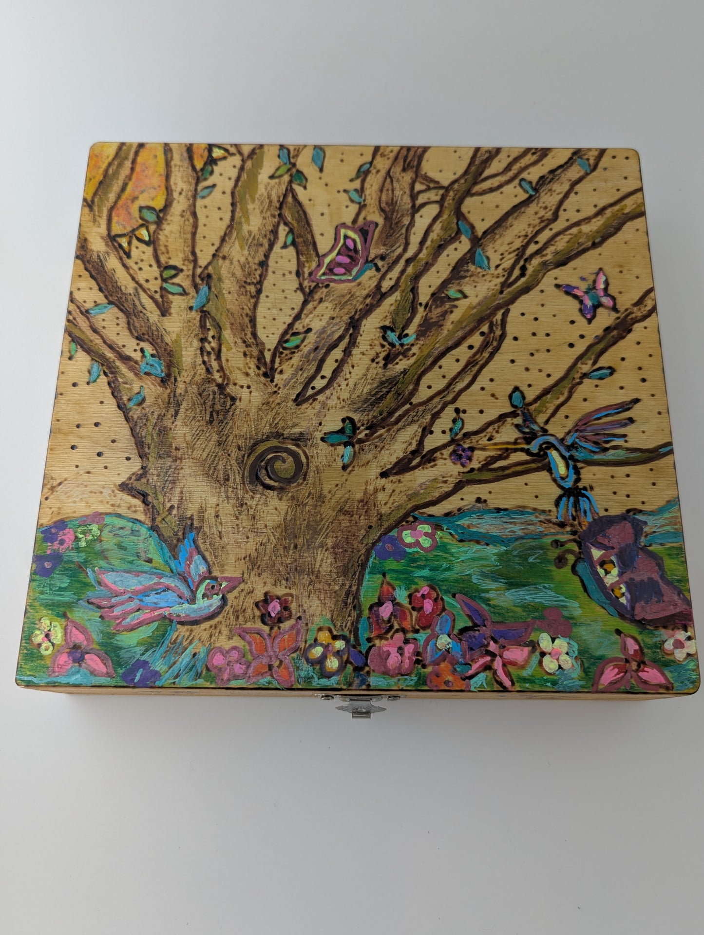 Decorative wooden box with a springtime design of a tree, birds, butterflies, and flowers 
