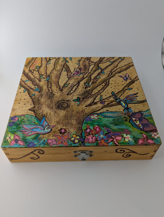 Decorative wooden box with a springtime design of a tree, birds, butterflies, and flowers 