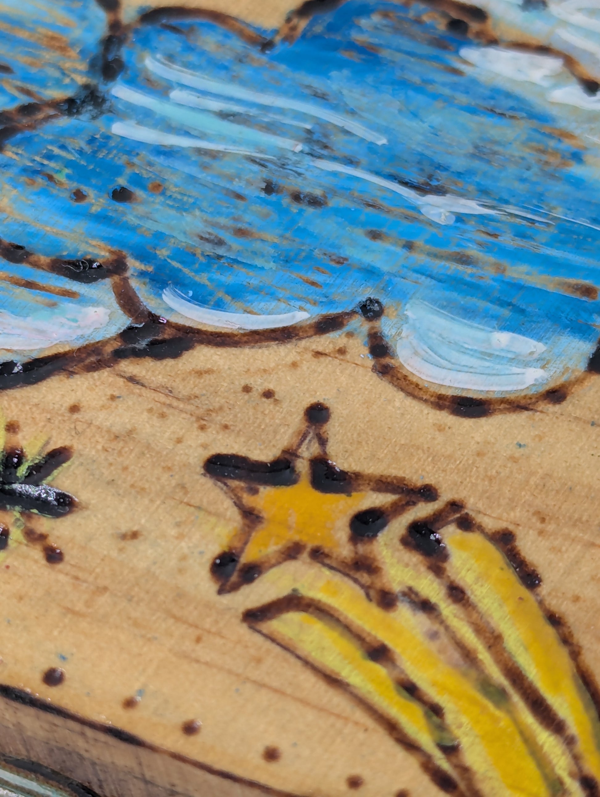 Close up of a decorative wooden box with cloud and star designs