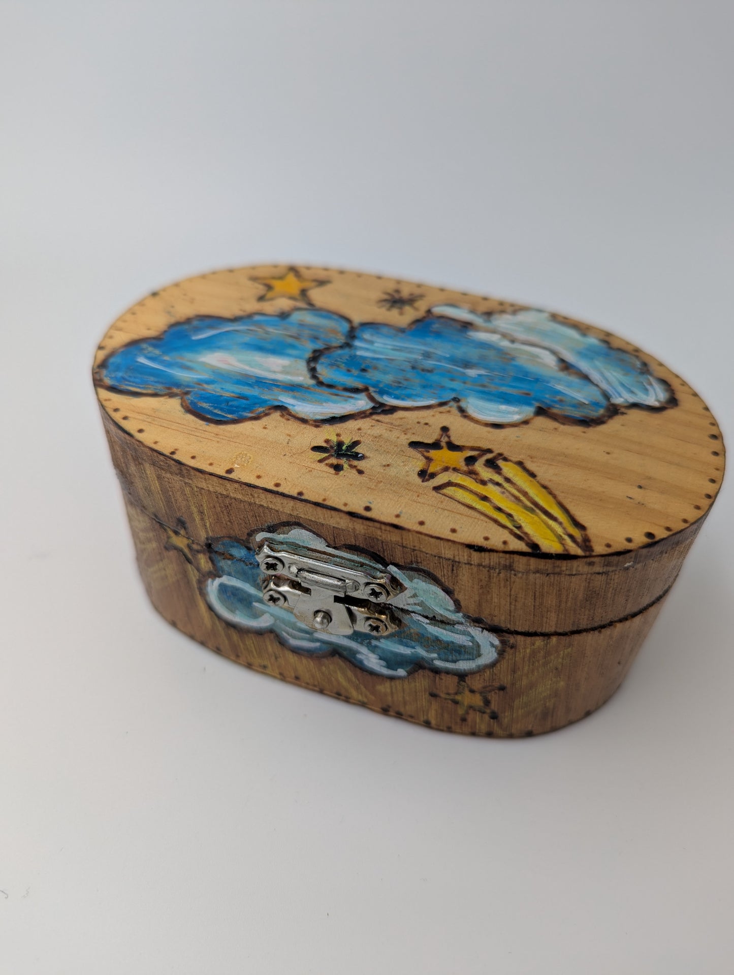 Decorative wooden box with cloud and star designs