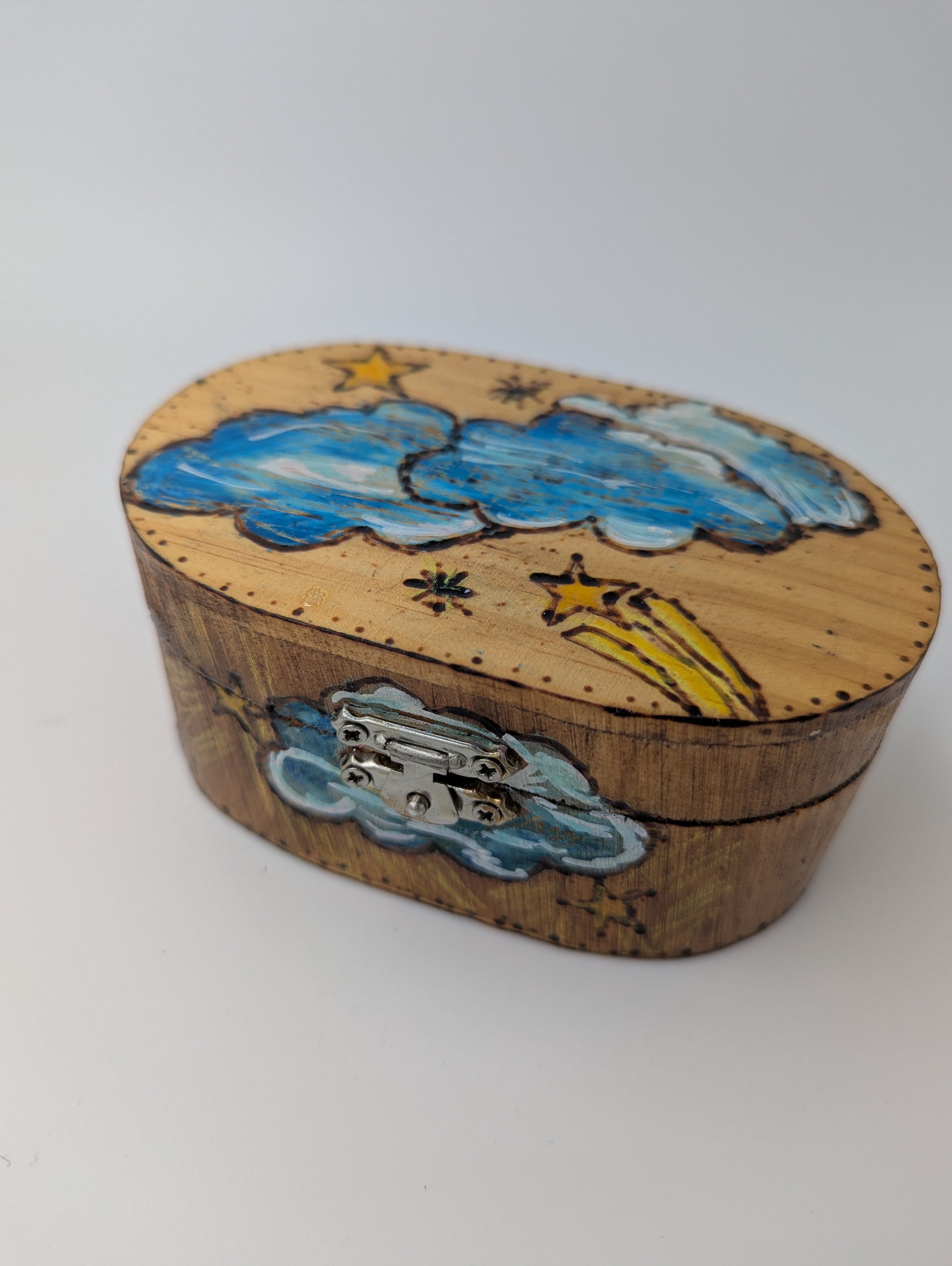 Decorative wooden box with cloud and star designs