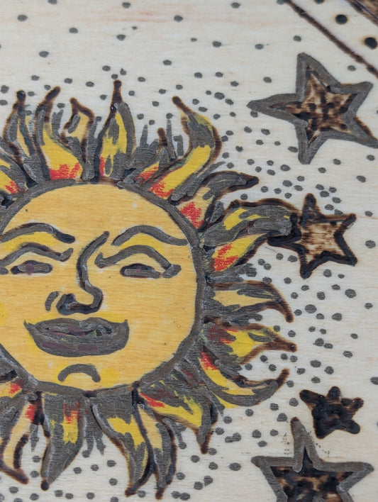 Close up of a decorative wooden box with sun and star design