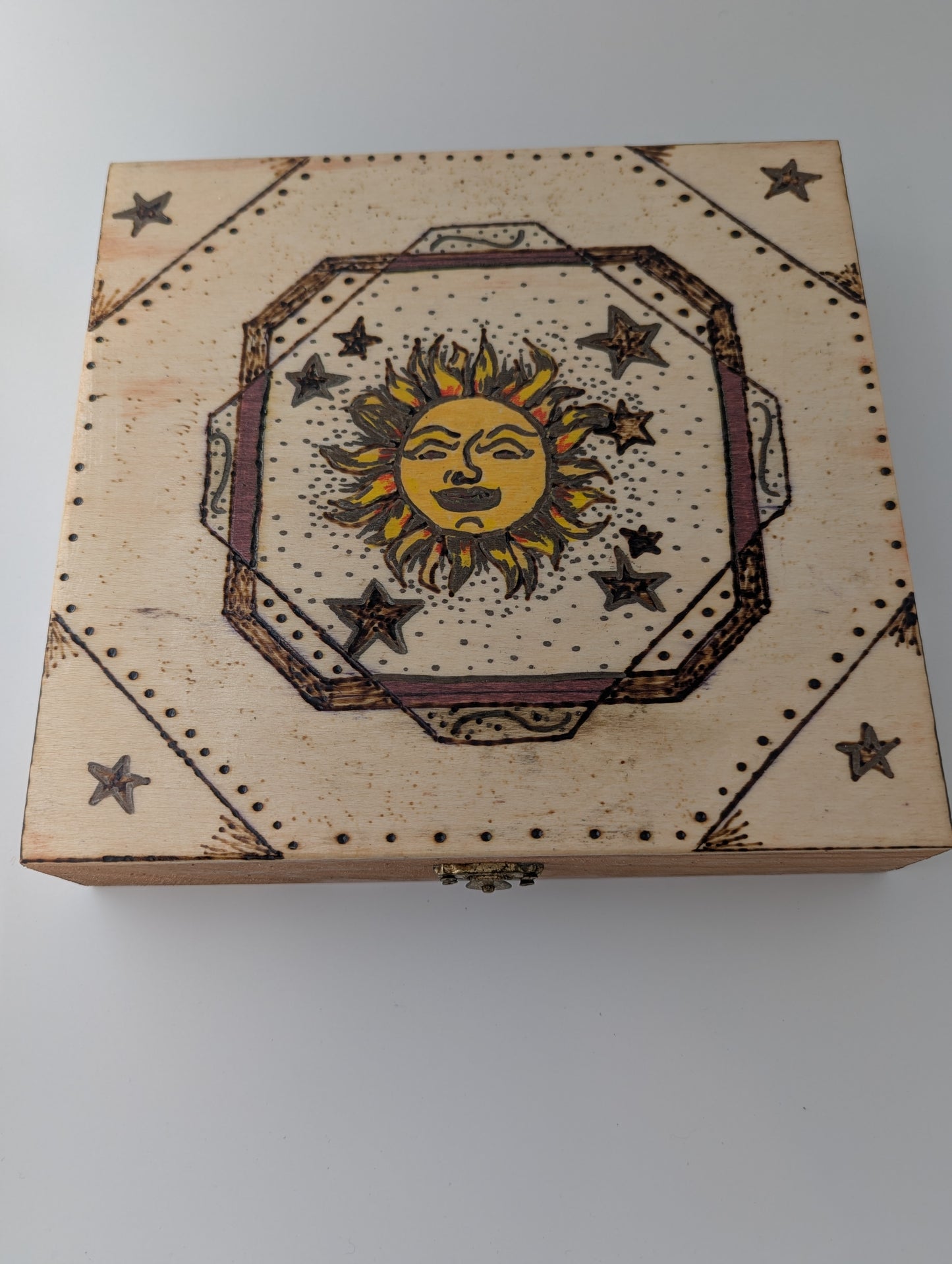 Decorative wooden box with sun and star design