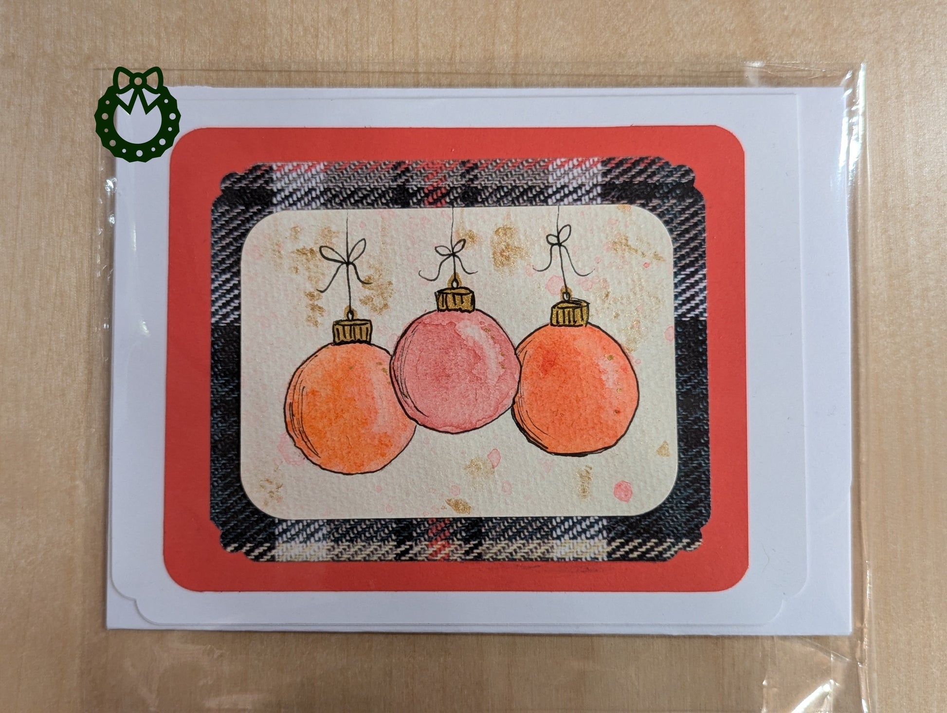 Card with Christmas ornaments on a plaid background