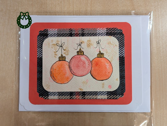Card with Christmas ornaments on a plaid background