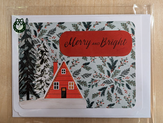 Christmas card with a red house, trees, and 'Merry and Bright' text on a patterned background.