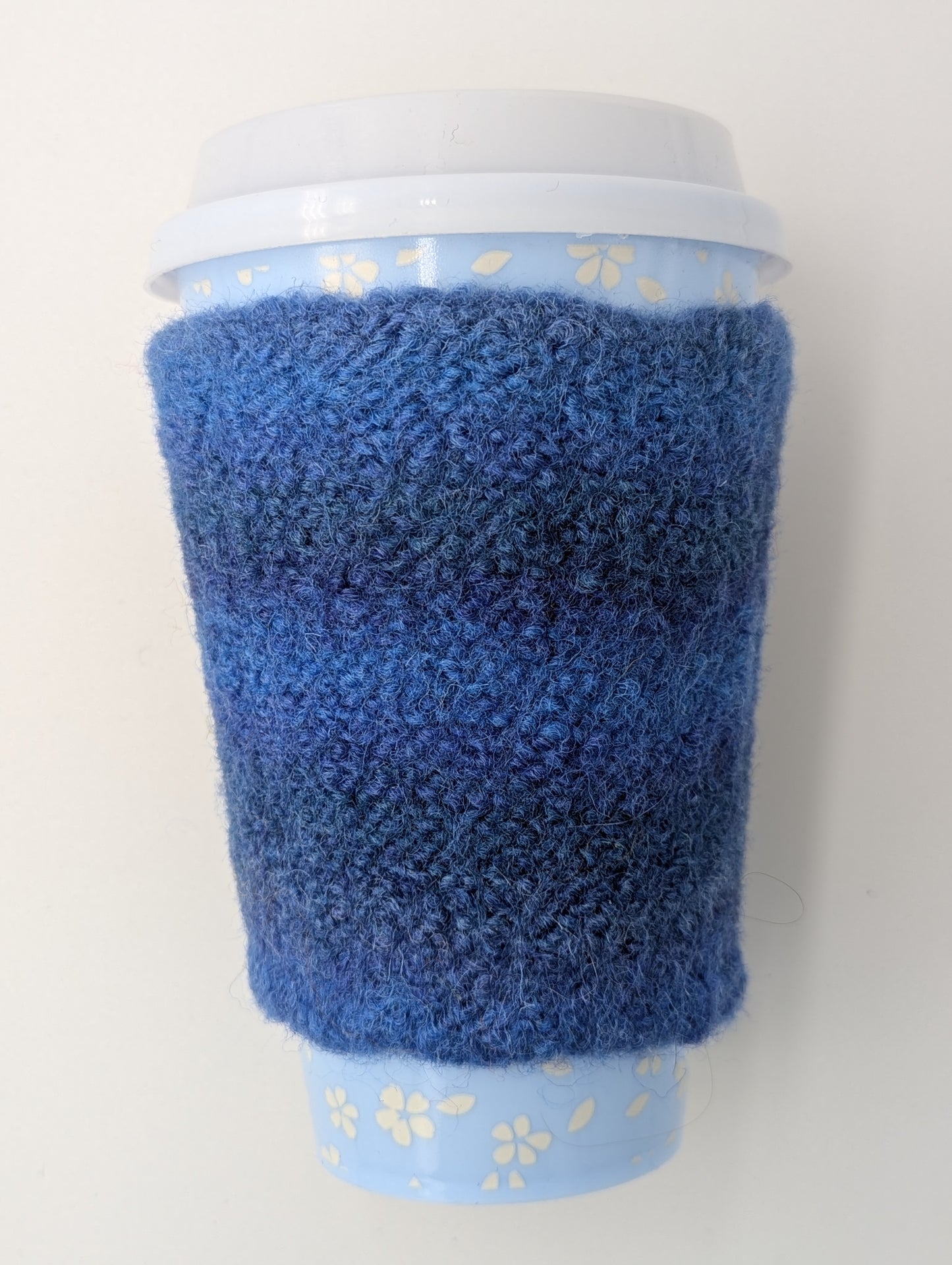 Blue knitted and felted mug cozy