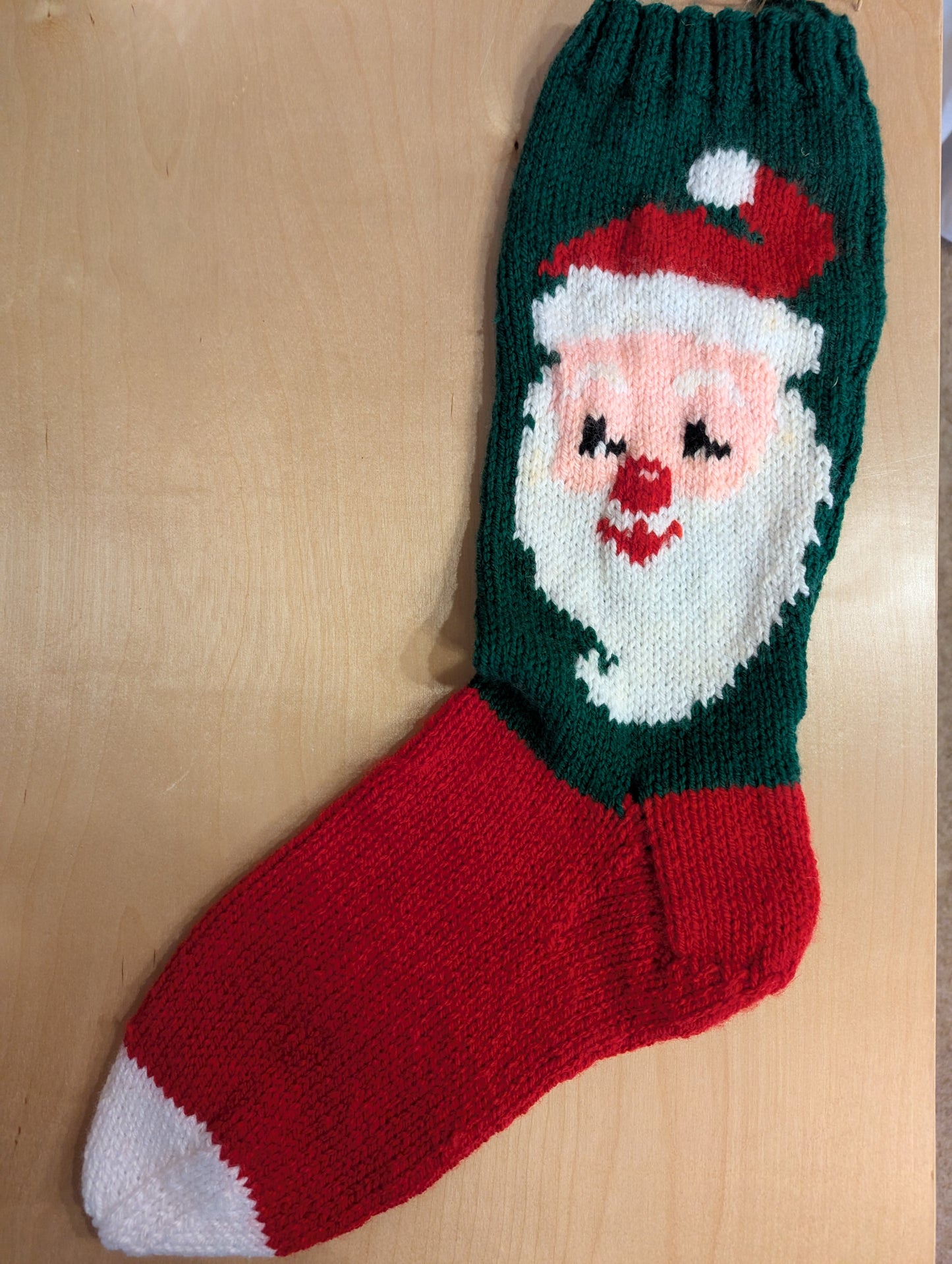 Hand knit Christmas stocking. This generous sized, classic hand knit stocking will bring cheer to any home.