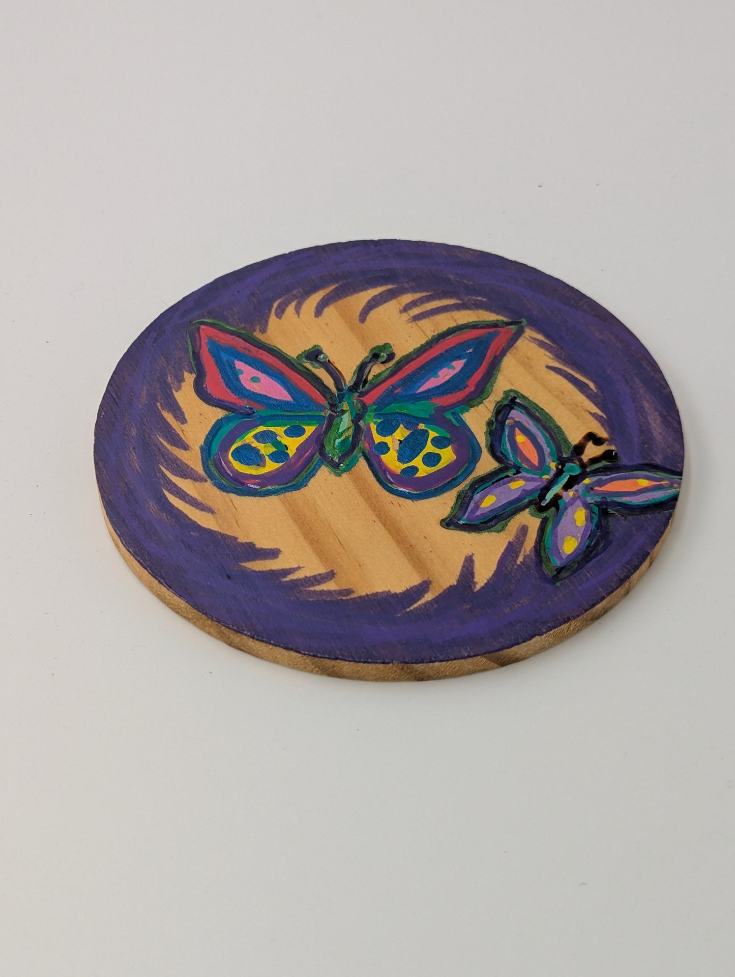 Wood burned and tole painted coaster with a butterfly design