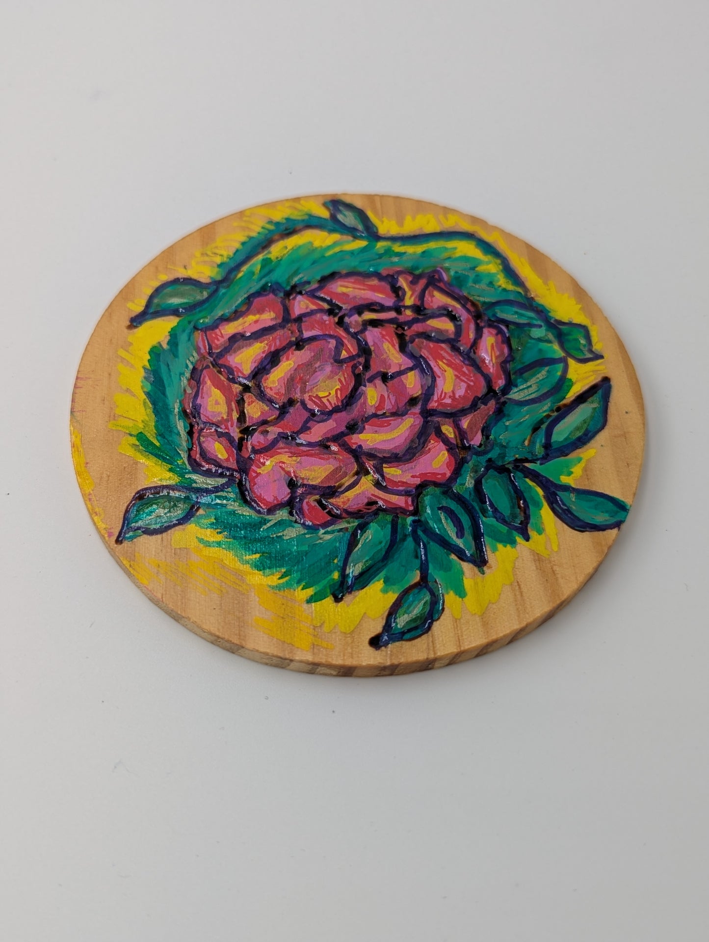 Wood burned and tole painted coaster with a rose design