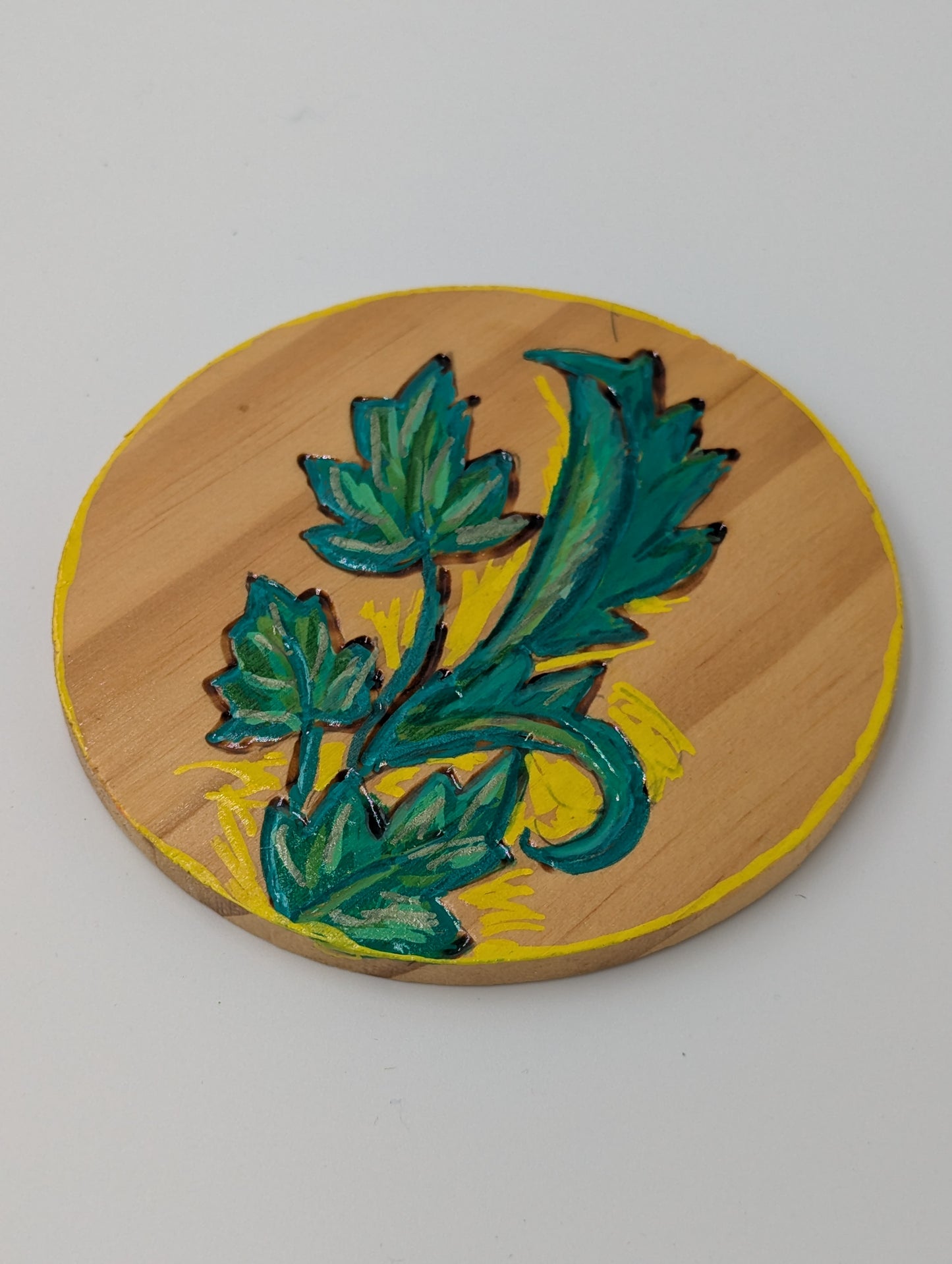 Wooden coaster, wood burned and tole painted with a green leaf design 