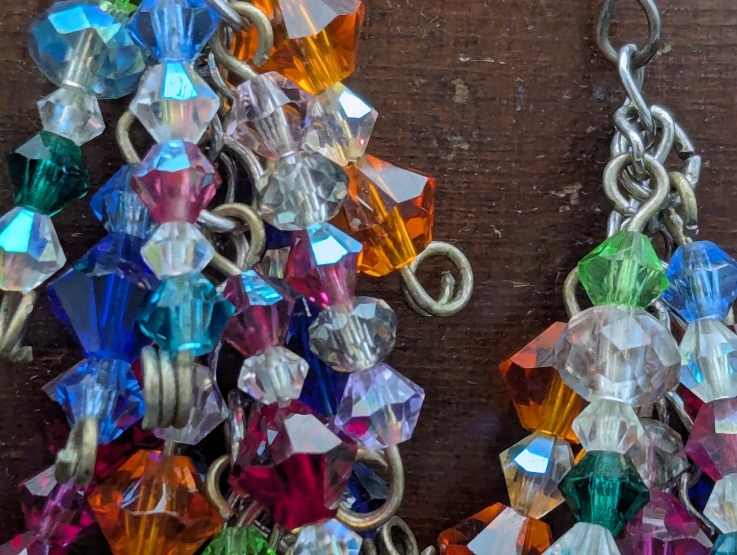 Close up of colorful beaded cascading earrings.