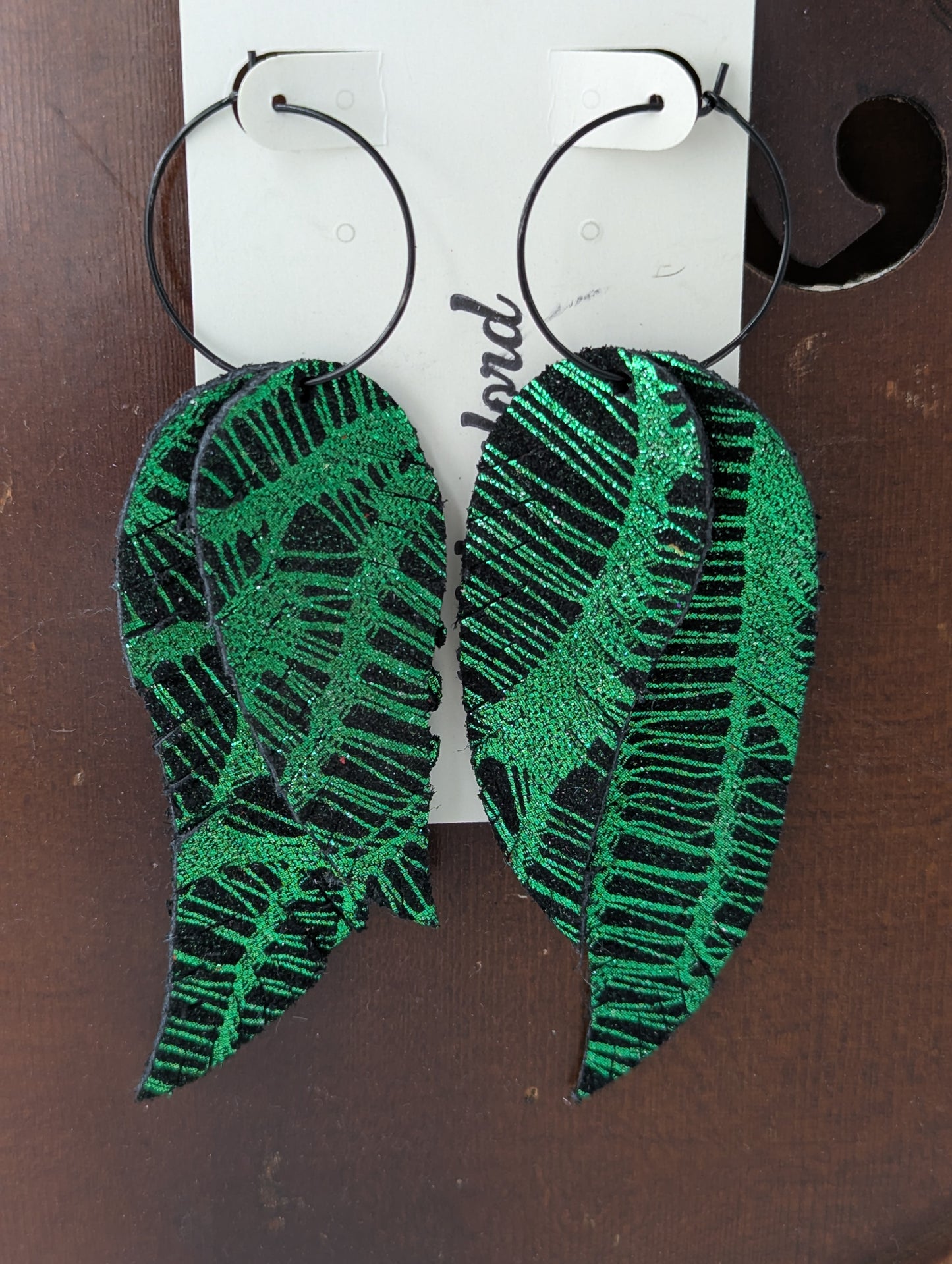 Leather leaf shaped earrings. Black and shimmery green on black hoops. 4 inches