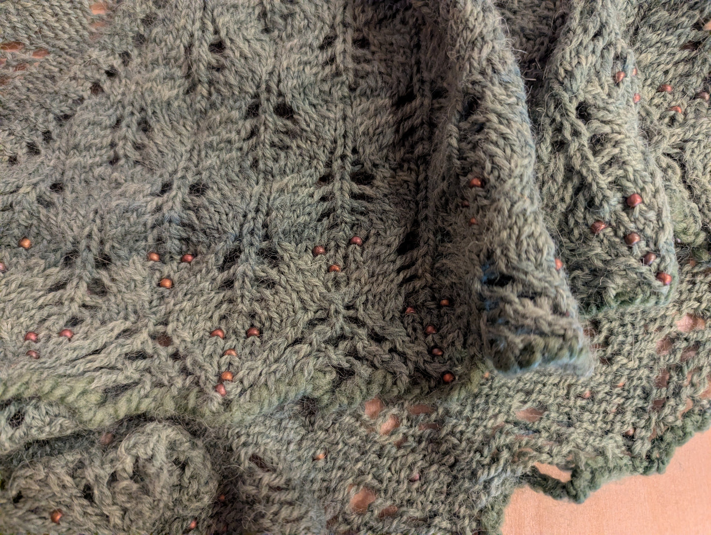 A hand knit lace shawl with beads woven in