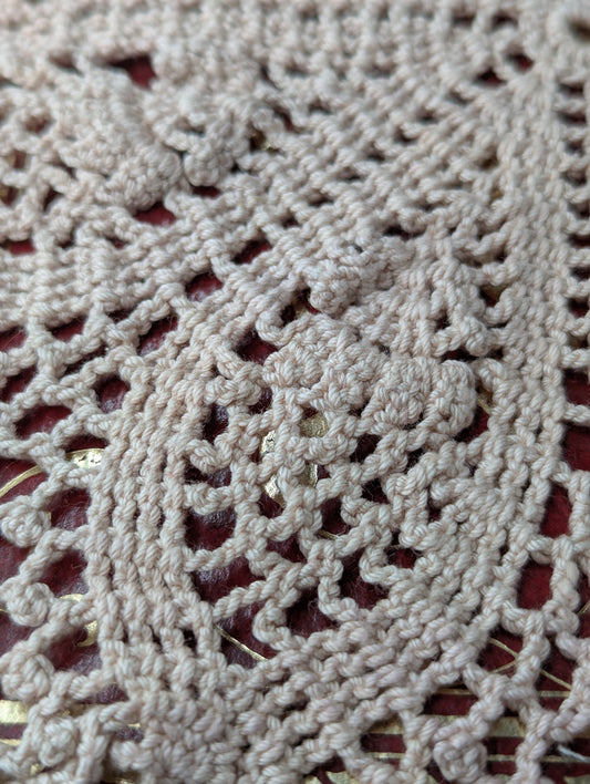 Close up of a crochet doily in a flowers and lace pattern