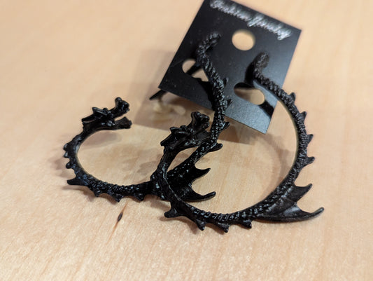 Hand made earrings. Coiling dragon earrings are ear jackets with tails that can be positioned out from the back of the ear or wrap up to lay on the front of the ear.