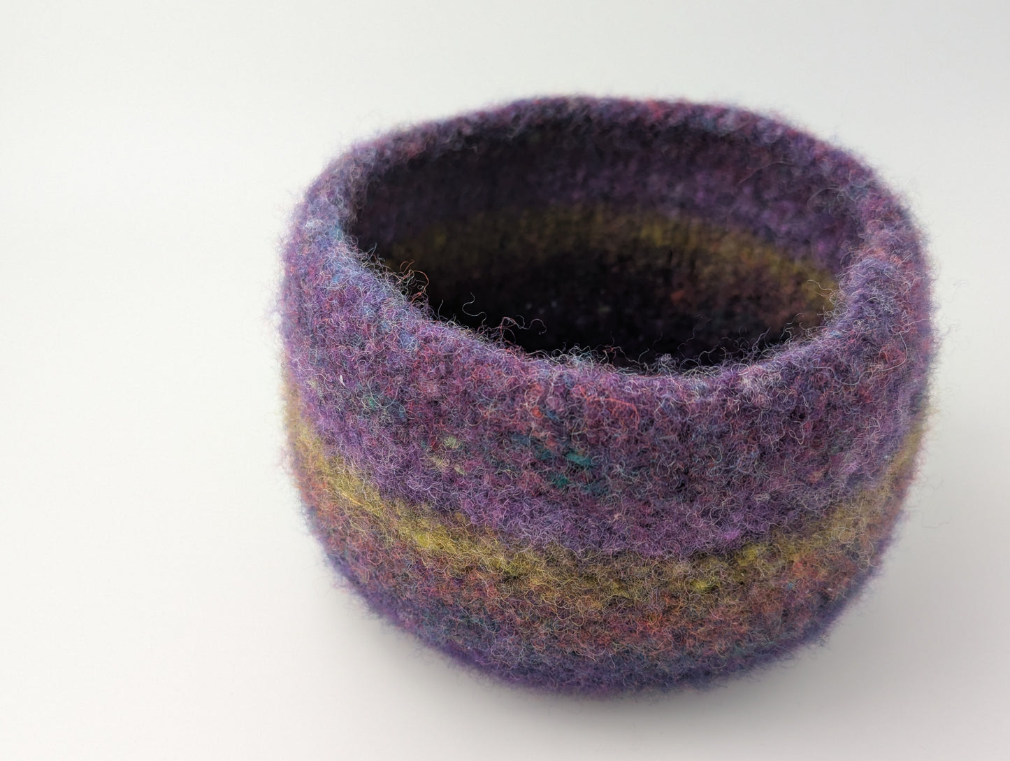 One bowl in a set of three felted bowls in colors reminiscent of Hellebore flowers