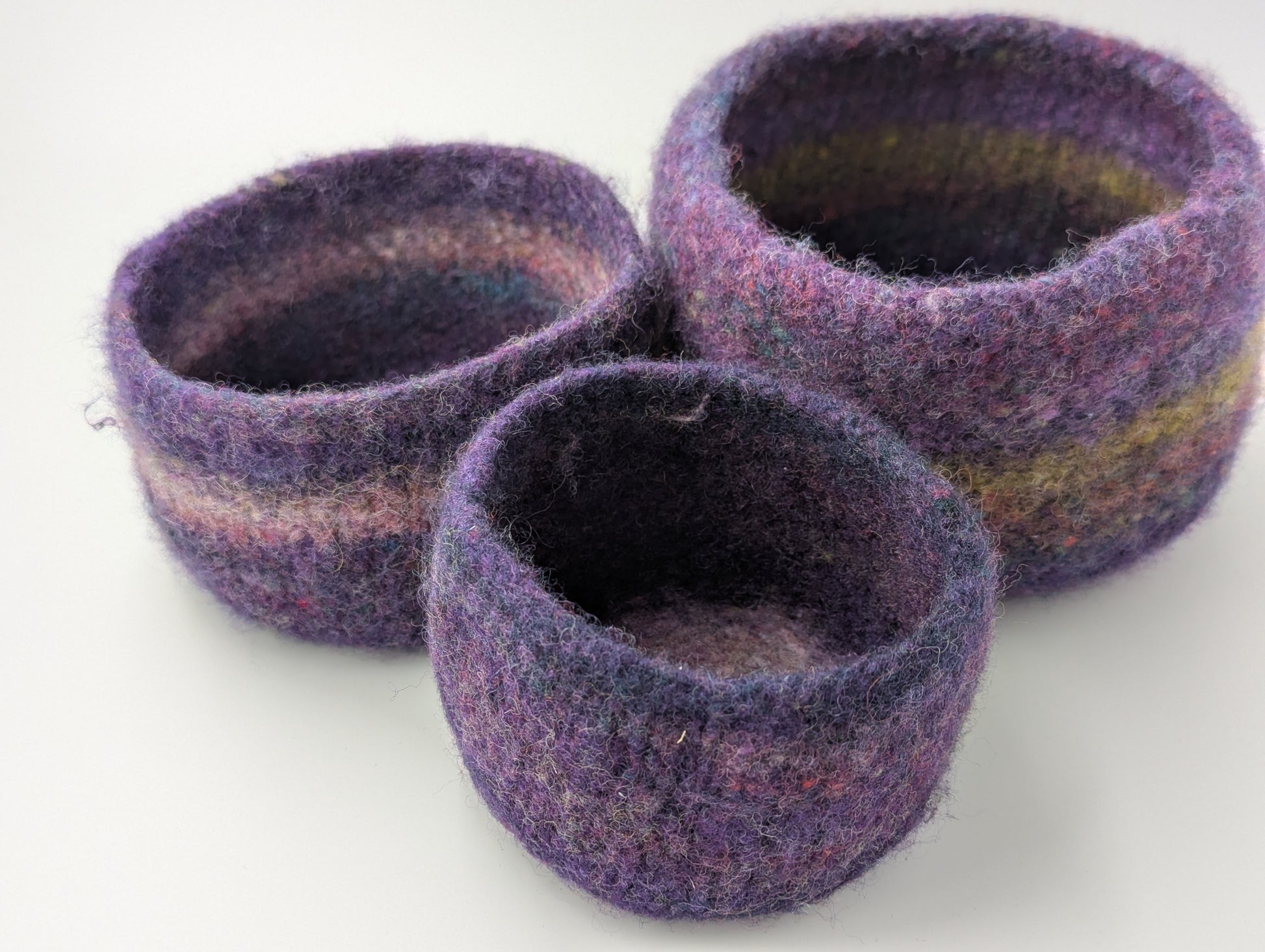 Set of three felted bowls in colors reminiscent of Hellebore flowers