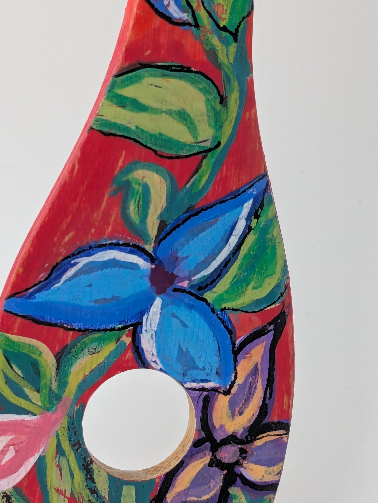 Close up of a colorful decorative wooden risotto spoon with floral patterns