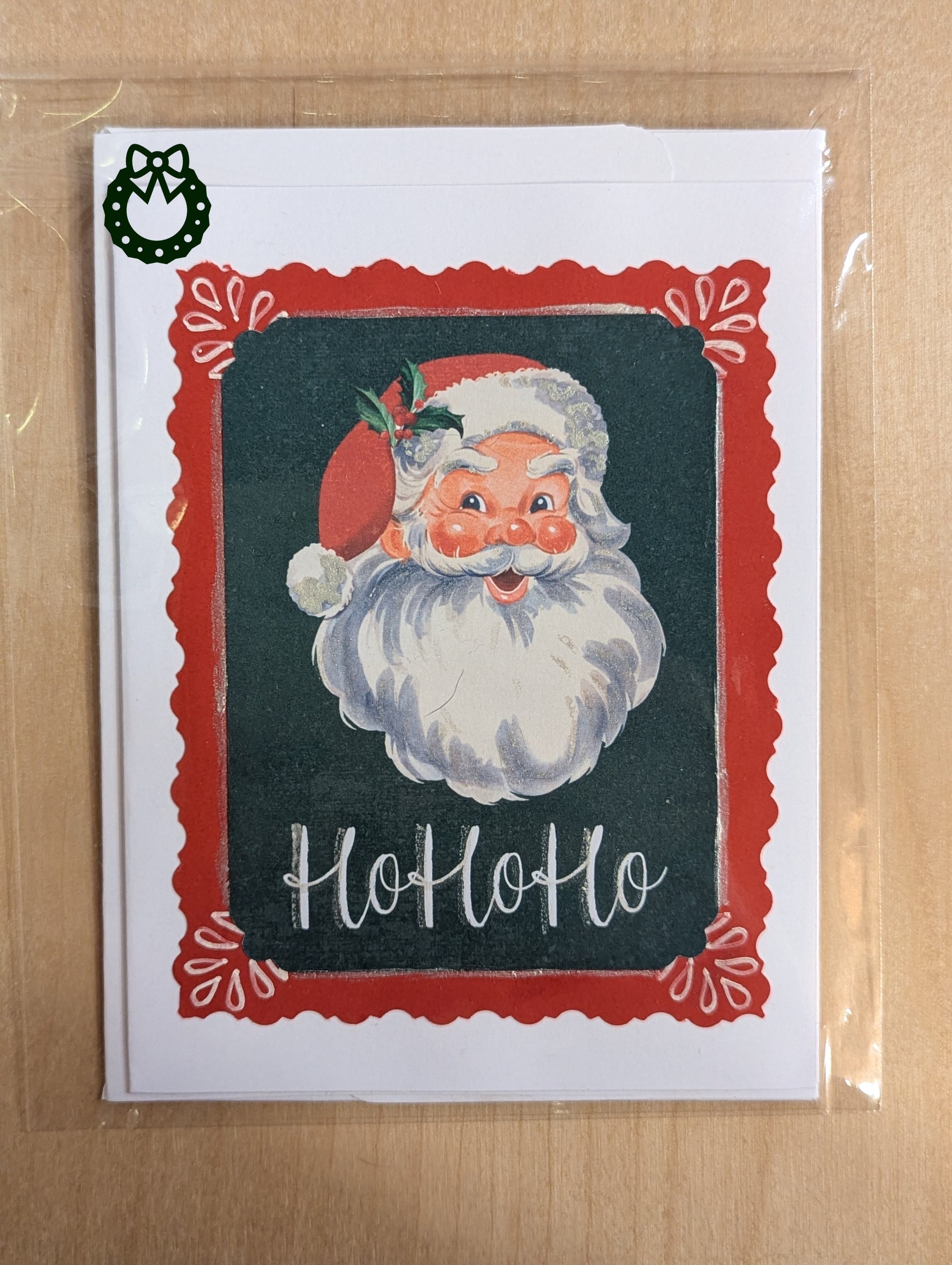 Vintage-style Santa Claus card with 'Ho Ho Ho' text with a green background and a red border.