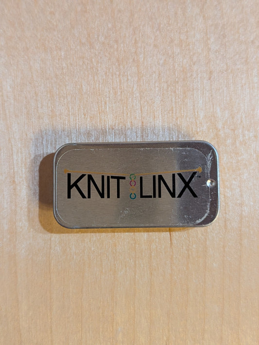 Metal storage box for row counters or stitch markers with 'KNIT LINX' logo on the top.