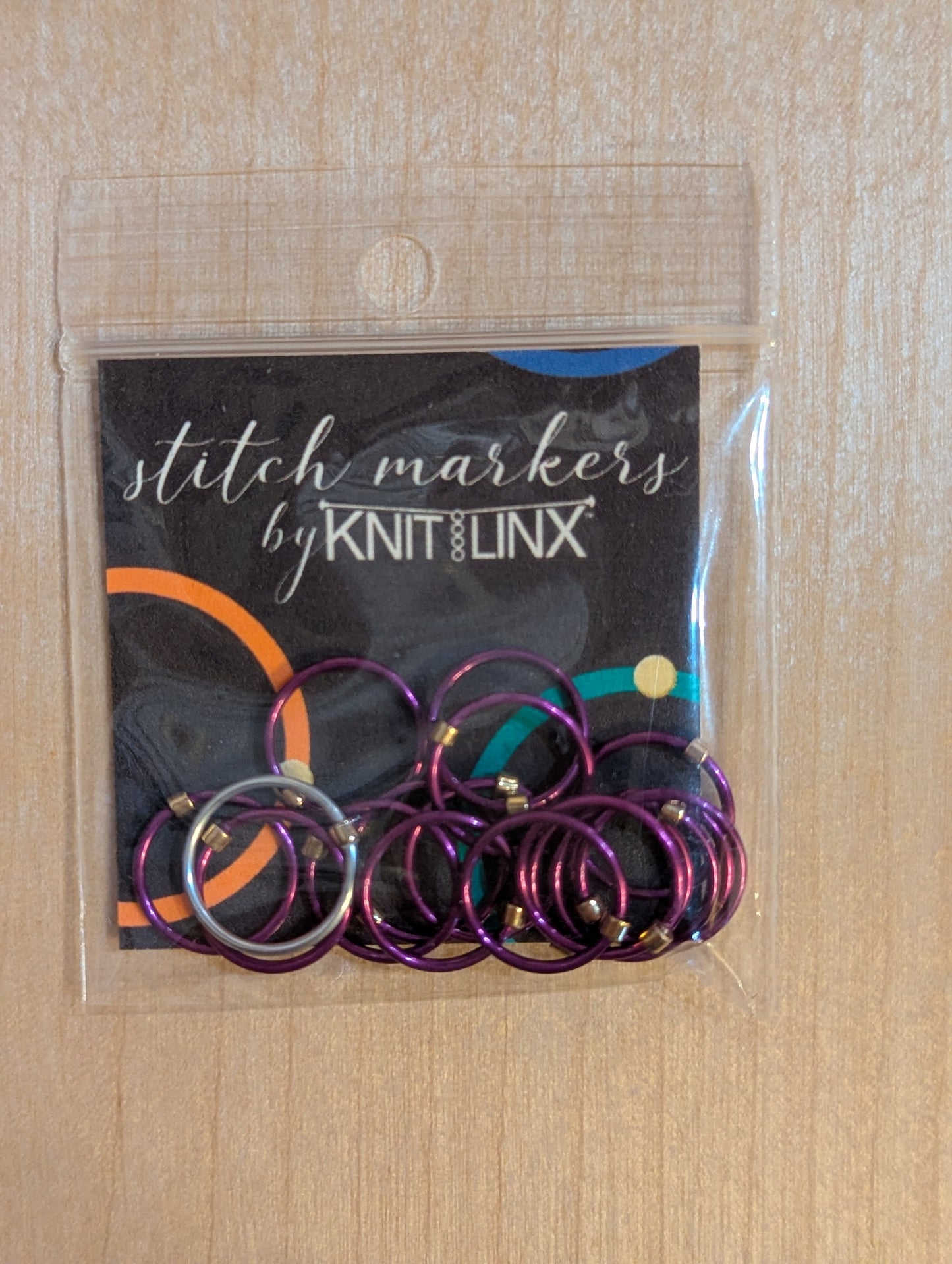 Knitting and crochet stitch markers by KnitLinx for knitting needles size 9 through 13. Made from metal, purple color.