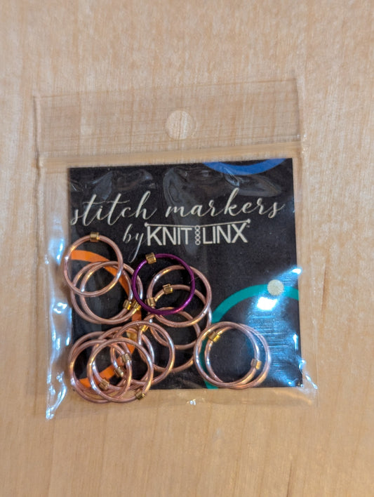 Knitting and crochet stitch markers by KnitLinx for knitting needles size 9 through 13. Made of metal, rose gold color.