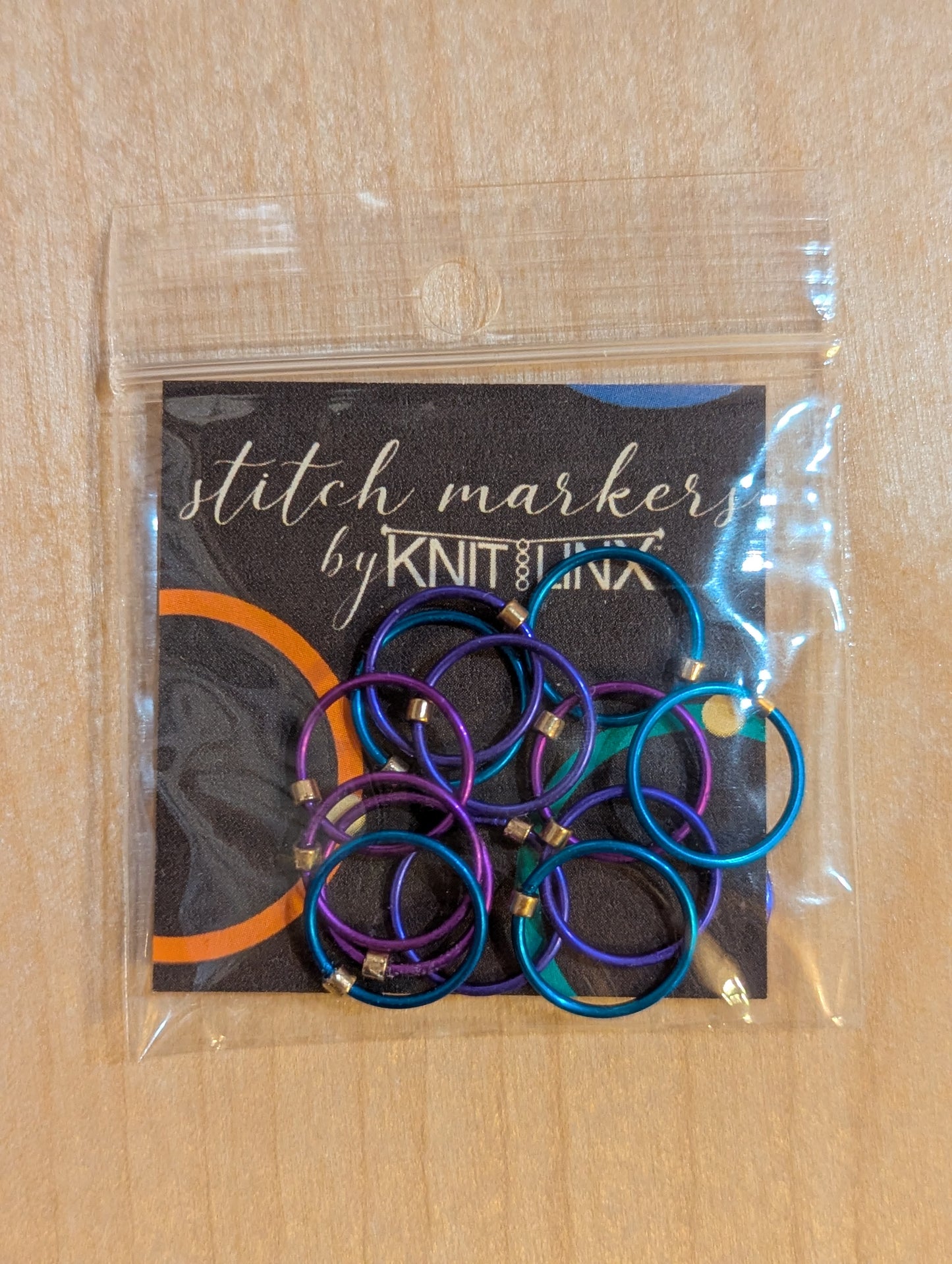 Knitting and crochet stitch markers by KnitLinx for knitting needles size 9 through 13. Made from metal in purple, blue and teal colors.