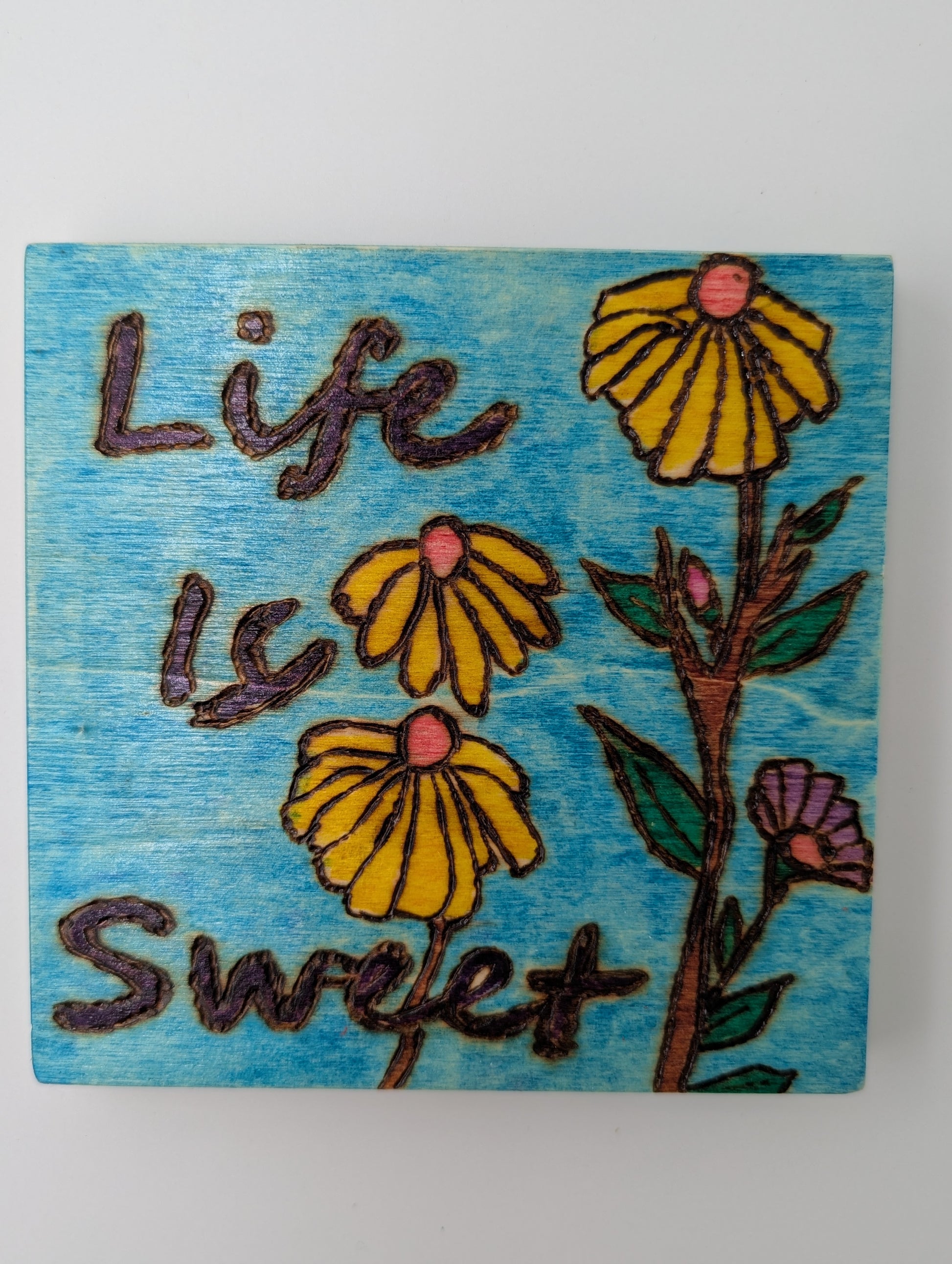 Original wooden wall art. Wood-burned and hand painted with 'Life is Sweet' and yellow flowers on a blue background.
