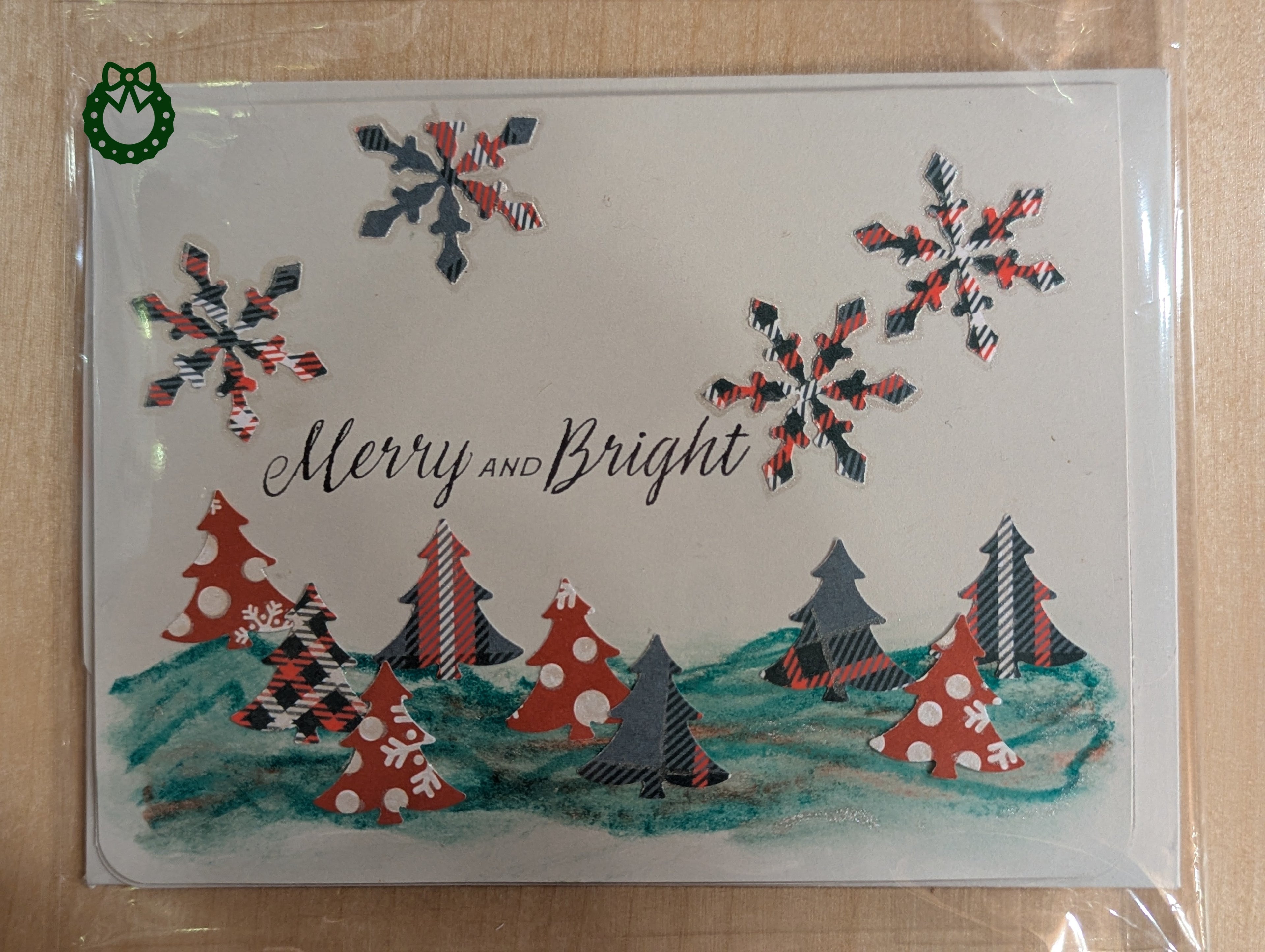 Christmas card with trees, snowflakes, and 'Merry and Bright' text on a white background.