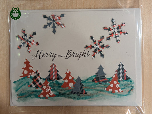 Christmas card with trees, snowflakes, and 'Merry and Bright' text on a white background.