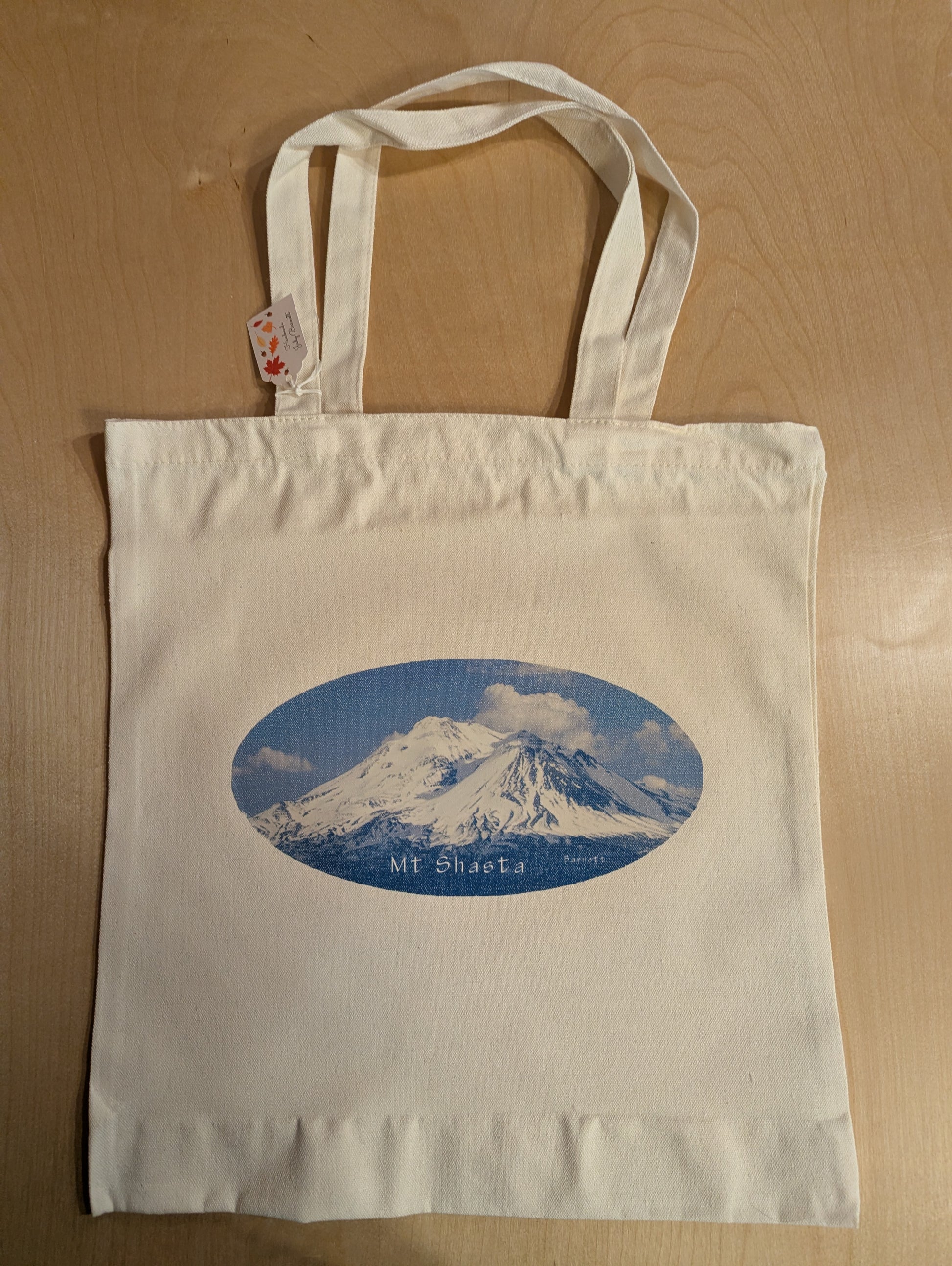 A handcrafted tote bag with a picture of Mt Shasta on it taken by a local photographer