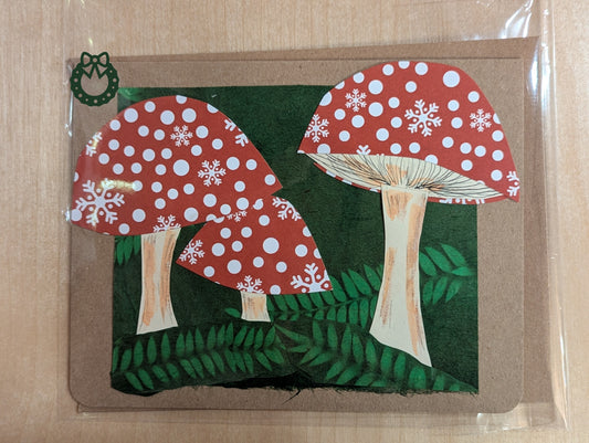 Christmas card with mushrooms with a green forest background