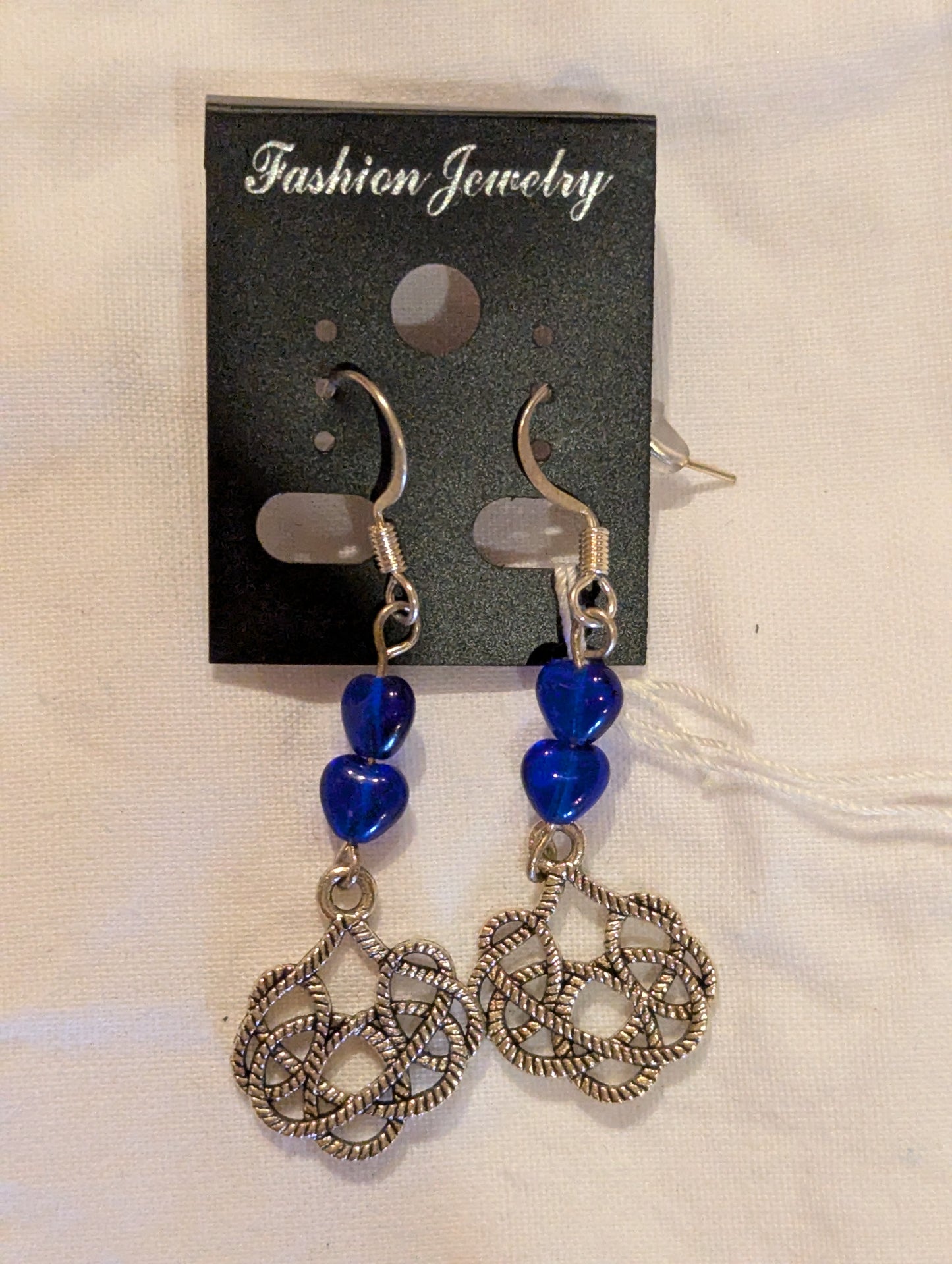 Earrings: silver Celtic knots with blue glass hearts