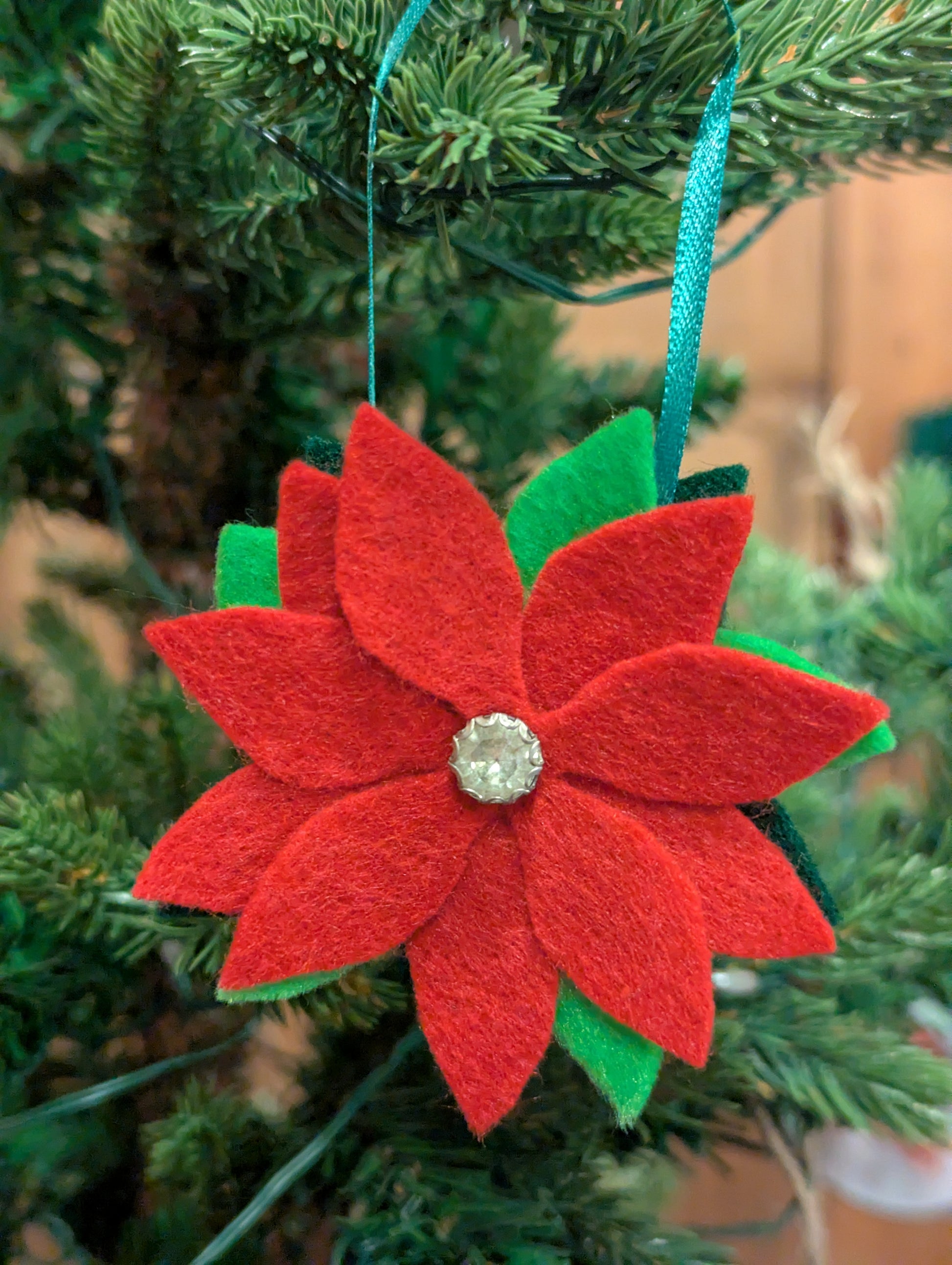 Red felt poinsettia flower ornament with a silver center
