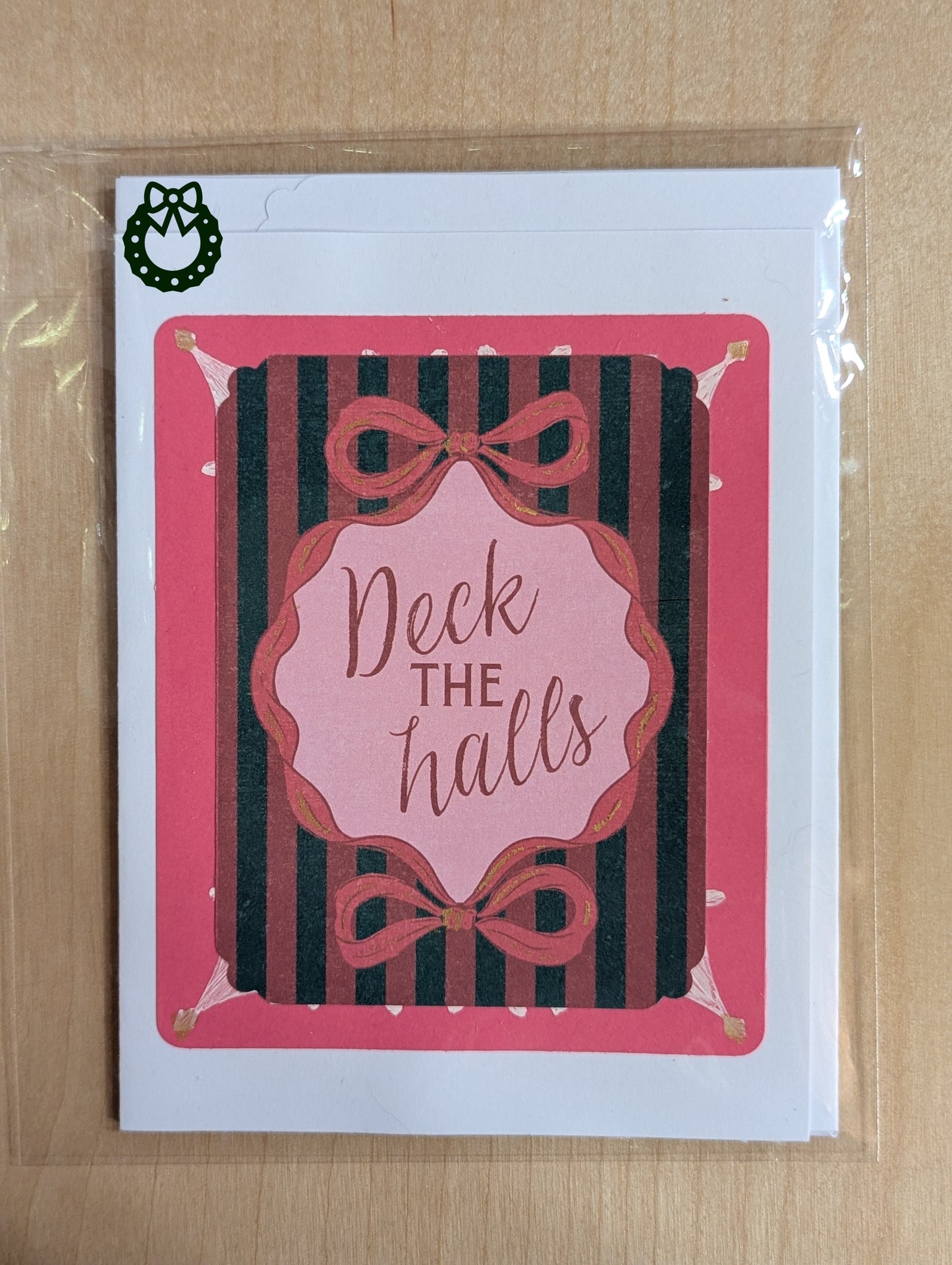 Christmas card with 'Deck the halls' text and decorative bows on a striped background