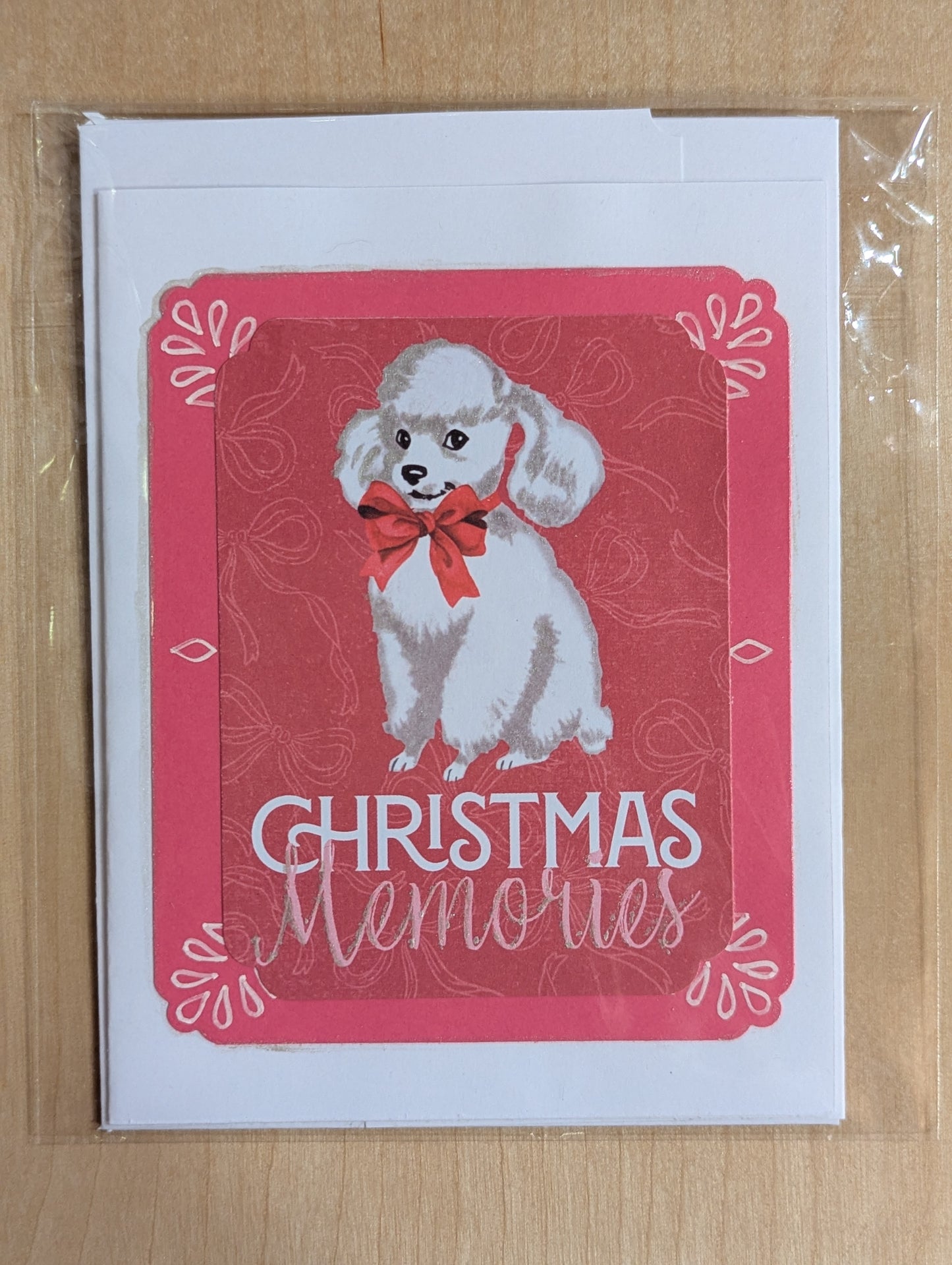 Poodle Christmas card with a red background and white lettering saying 'Christmas Memories'