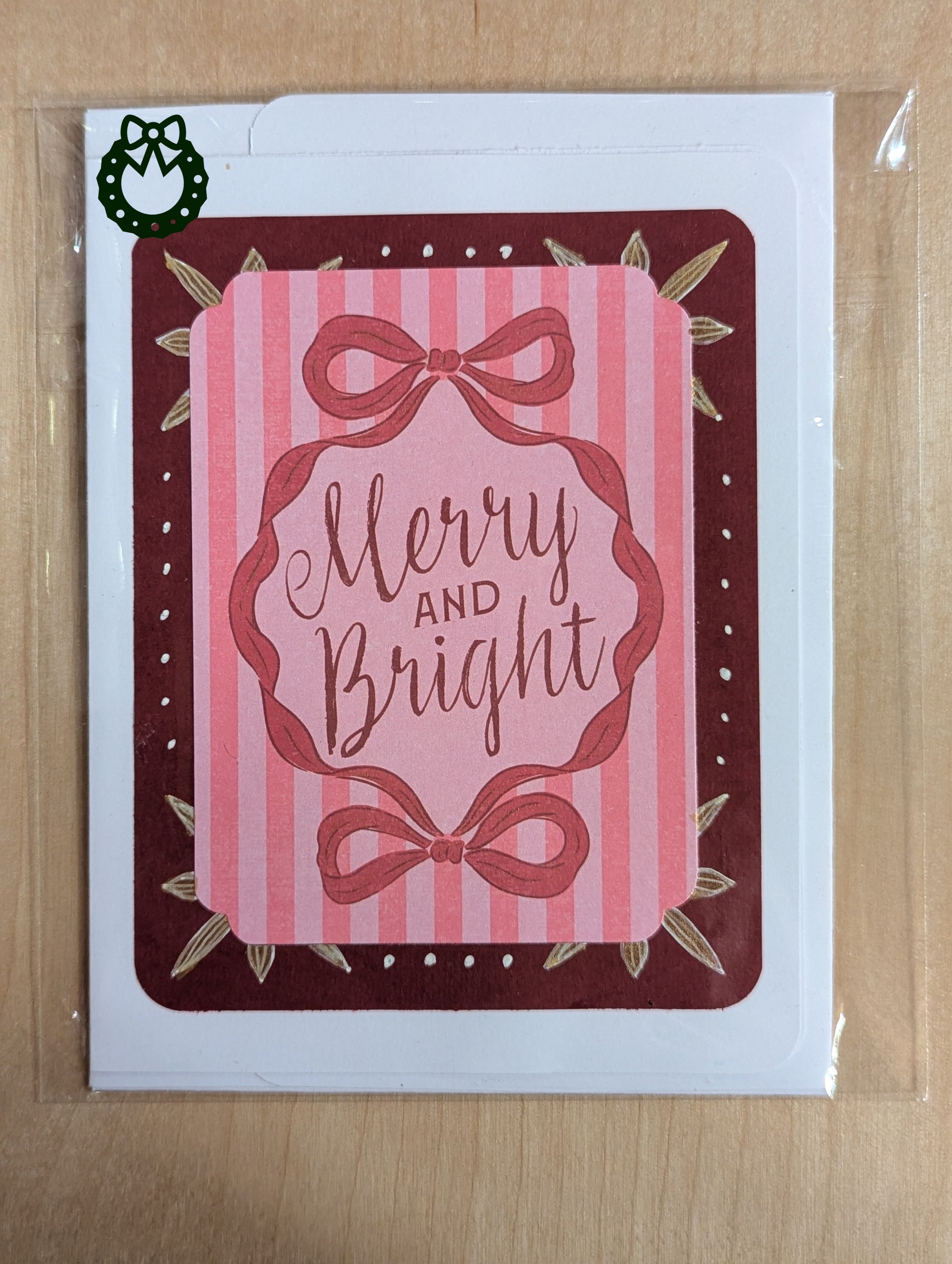 Retro style Christmas card saying 'Merry and Bright' on a pink stripped background