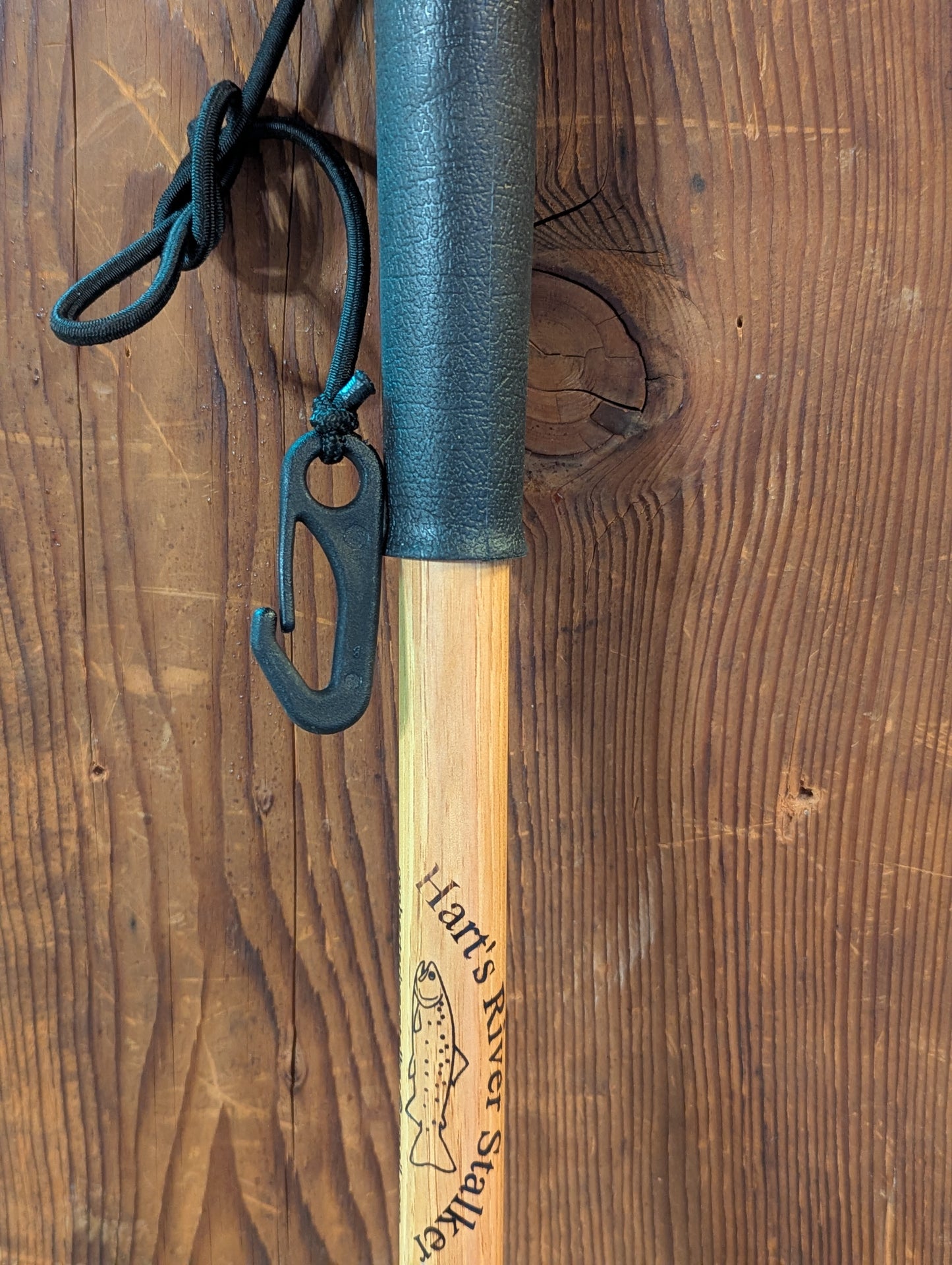 Detail of the handle of a handcrafted fly fishing accessory to stabilize you while walking in water.